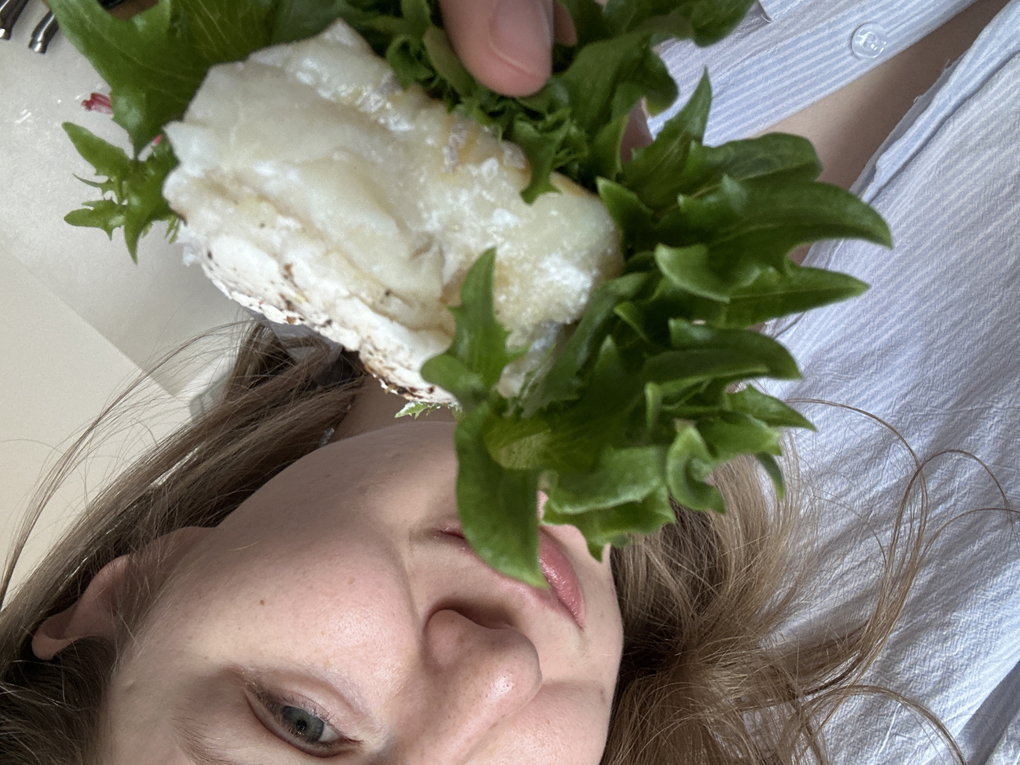 Person poses with sandwich in Kazan
