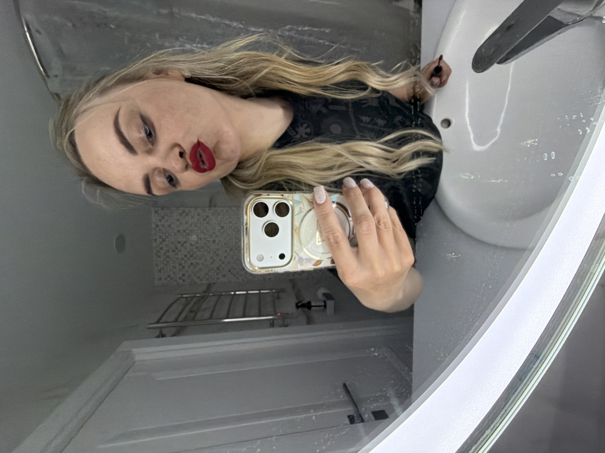 Woman takes selfies while applying makeup in Votkinsk
