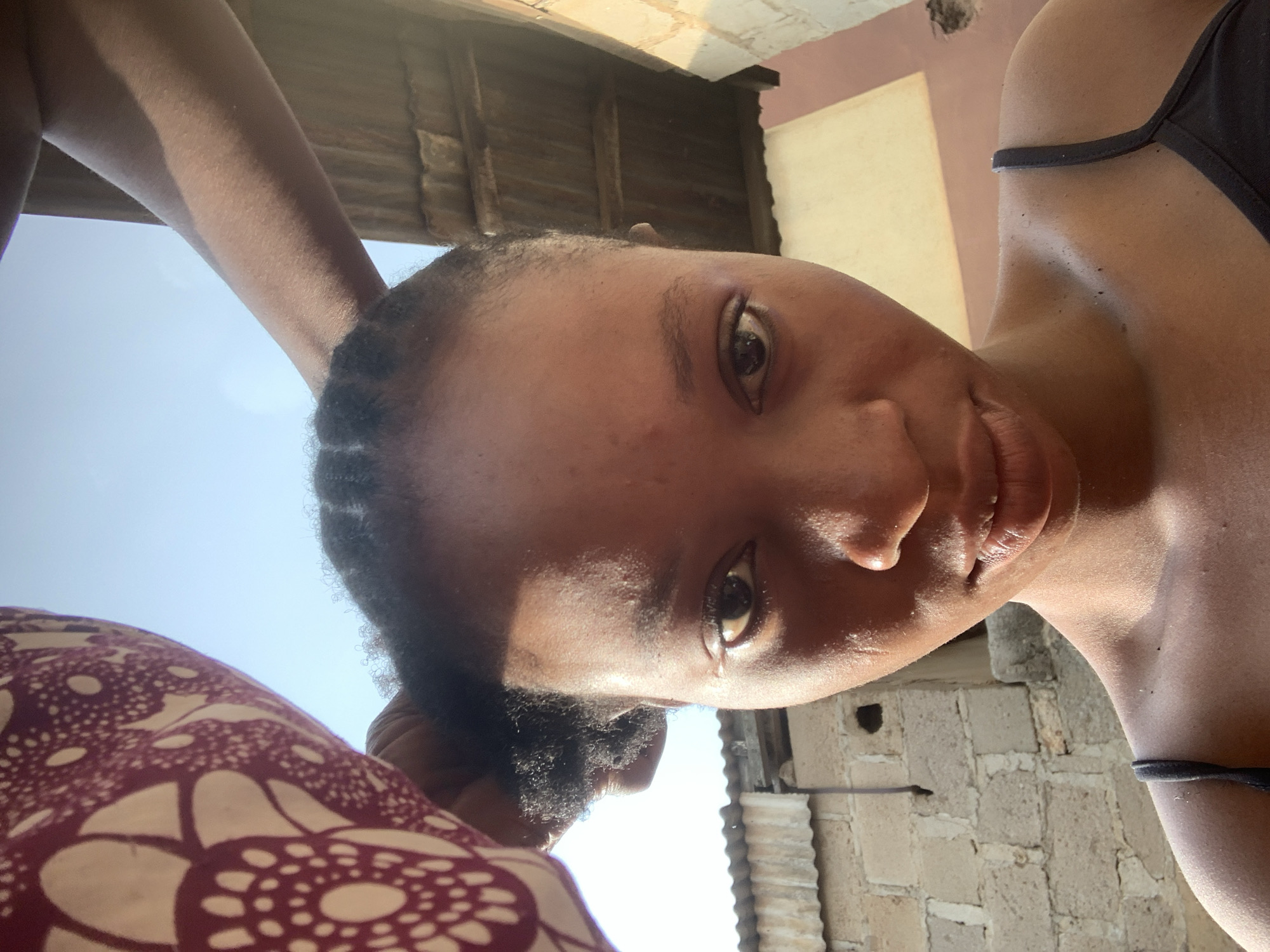 Morning in a Shagamu courtyard: hair braiding, cooking, casual selfies