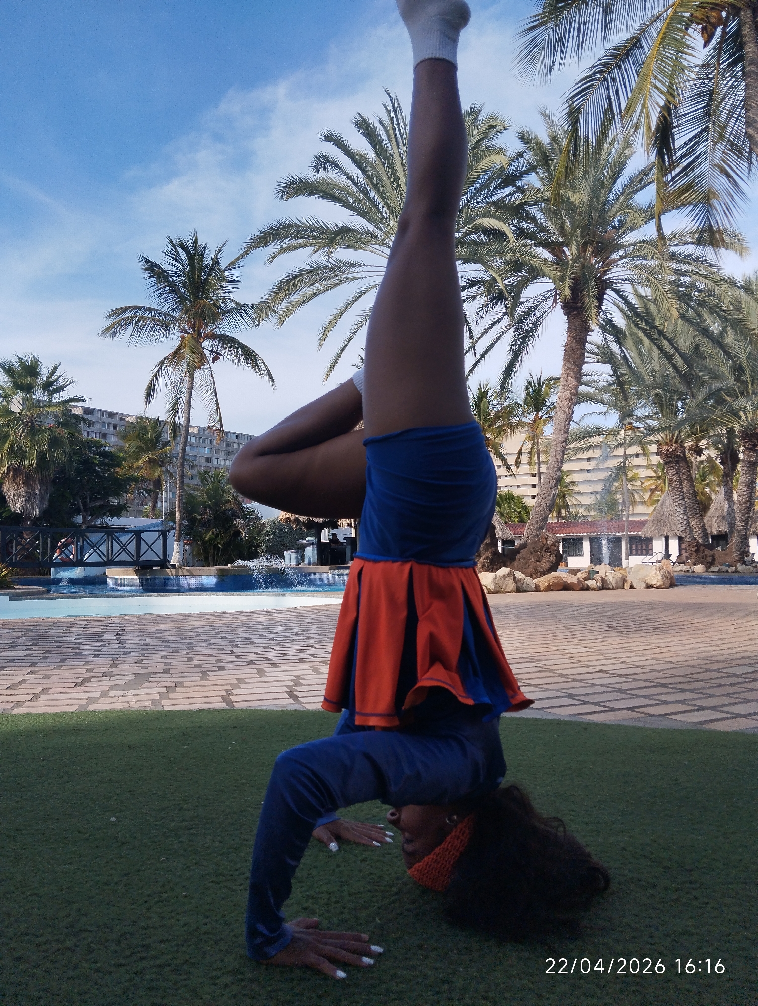 Person performs acrobatic handstands and backbends on artificial turf