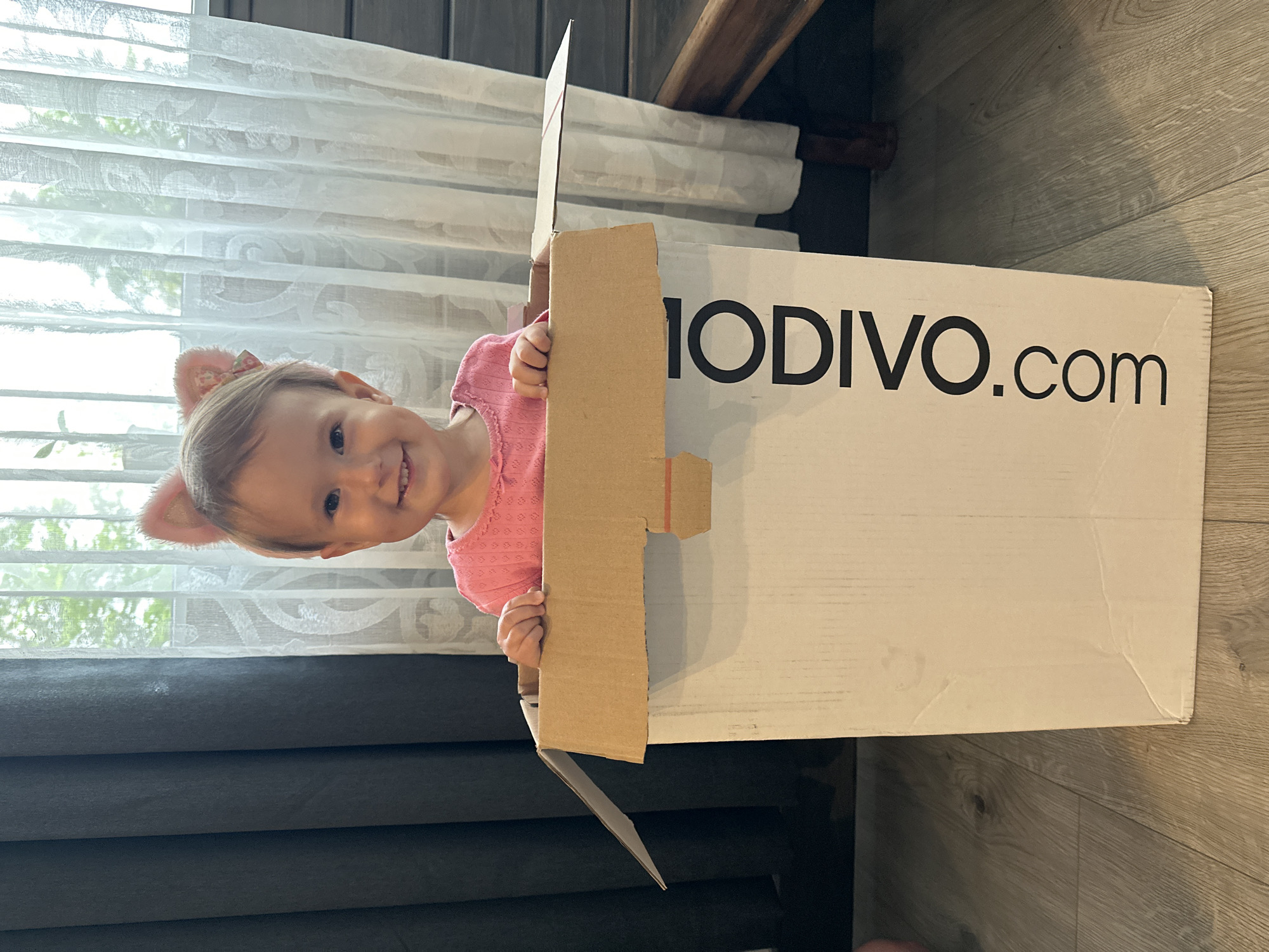 Child plays in cardboard box in Wisła, Poland