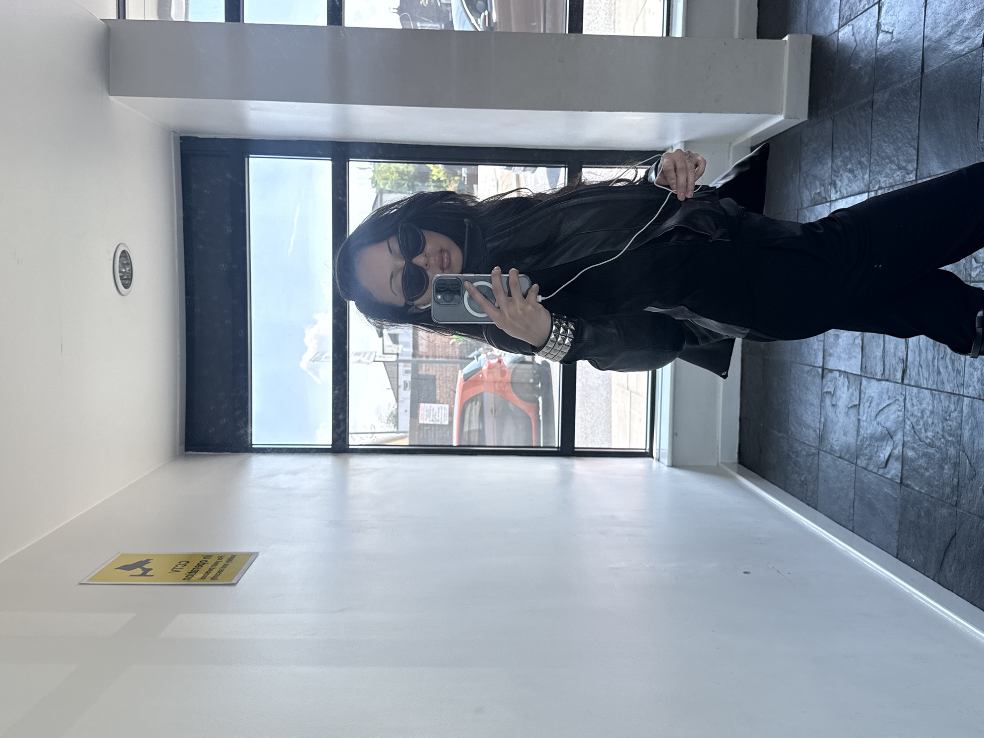 Woman takes mirror selfie in modern London building