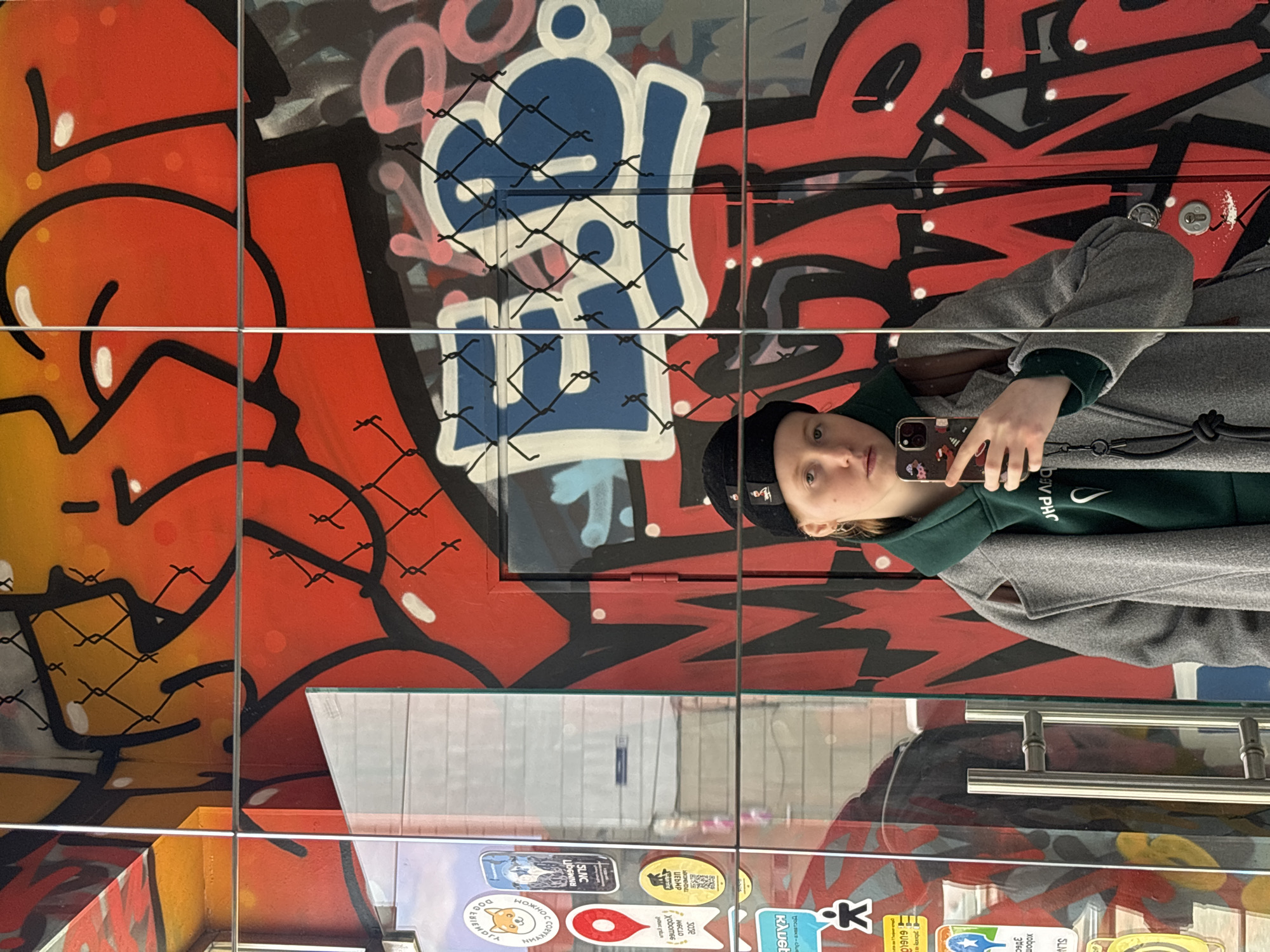 Young person documents street art scene in Perm cafe