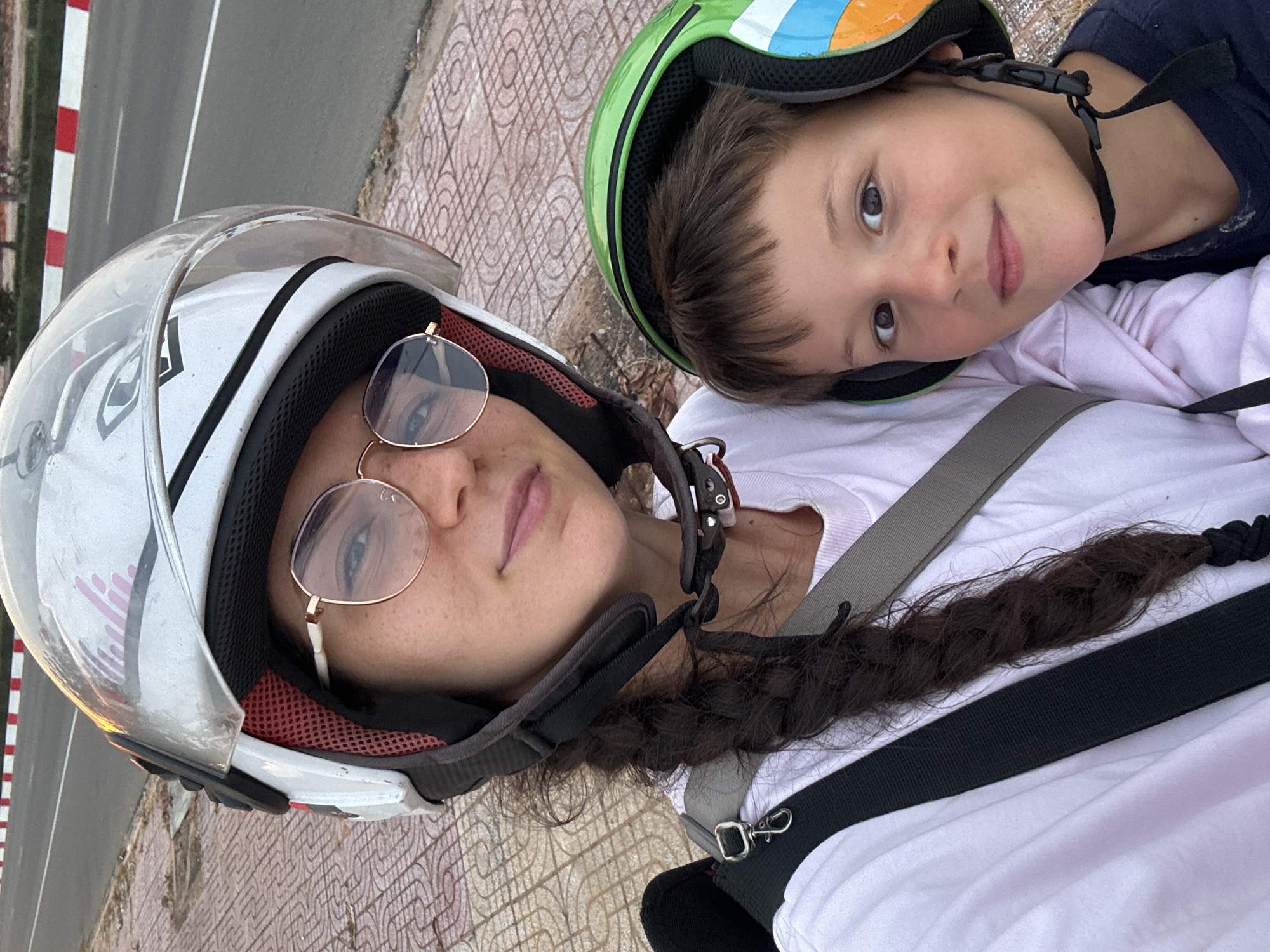 Woman and boy pose for photo in helmets, Mui Ne