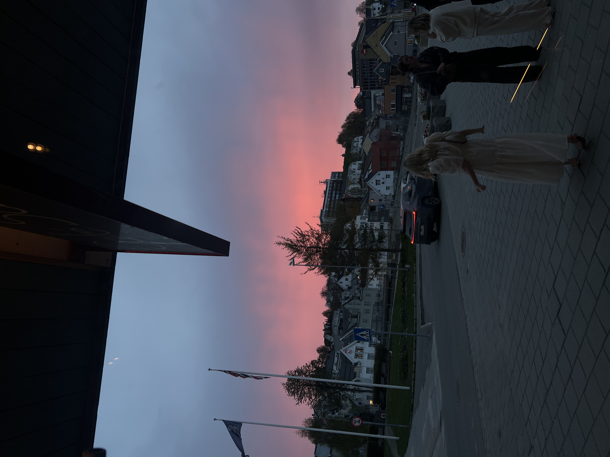 Twilight street life captured across Tromsø during evening hours
