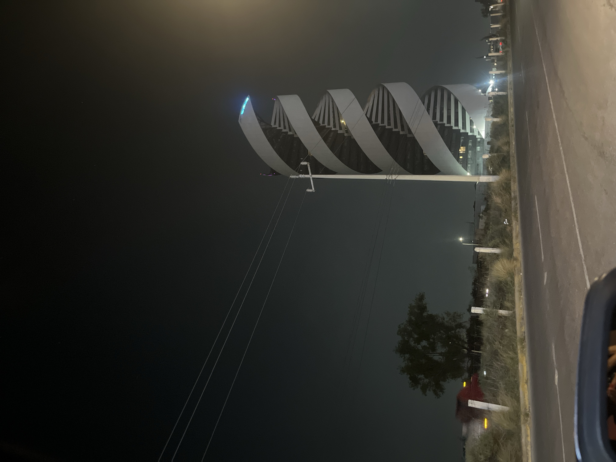 Modern spiral pedestrian bridge documented at night in Tlaxcalancingo