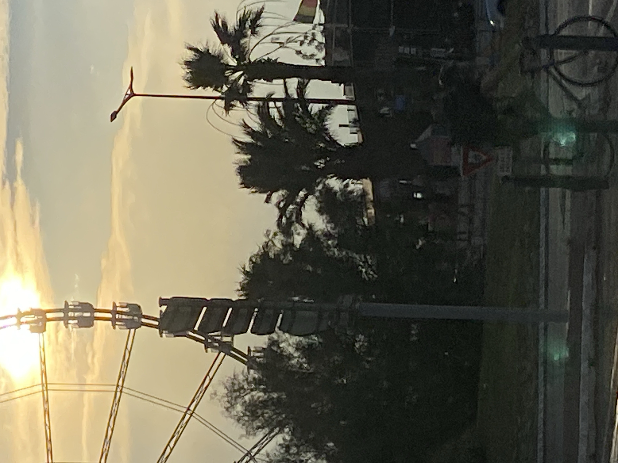 Ferris wheel and city streets at hazy sunset