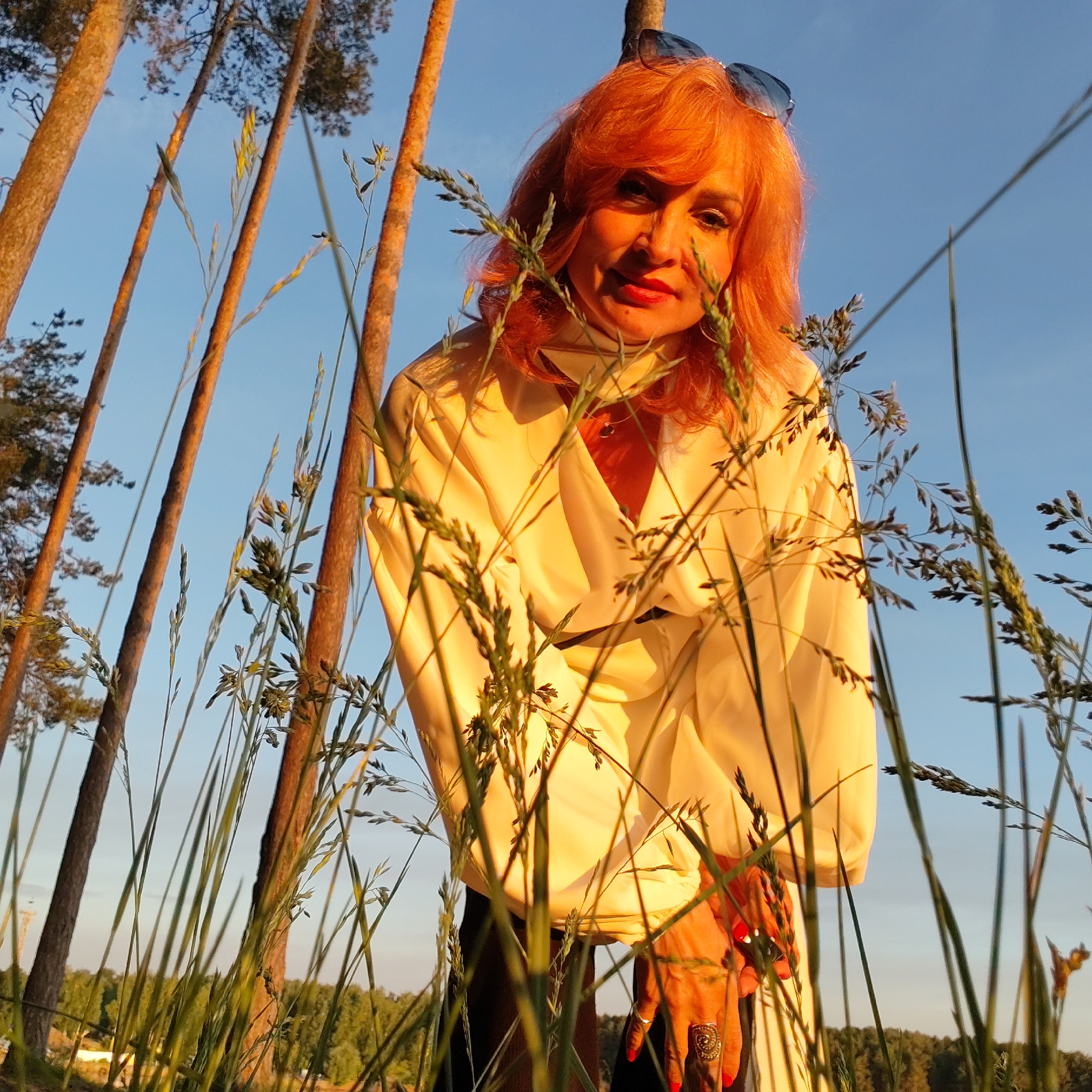 Woman photographs golden hour scenes in Chaikovsky forest