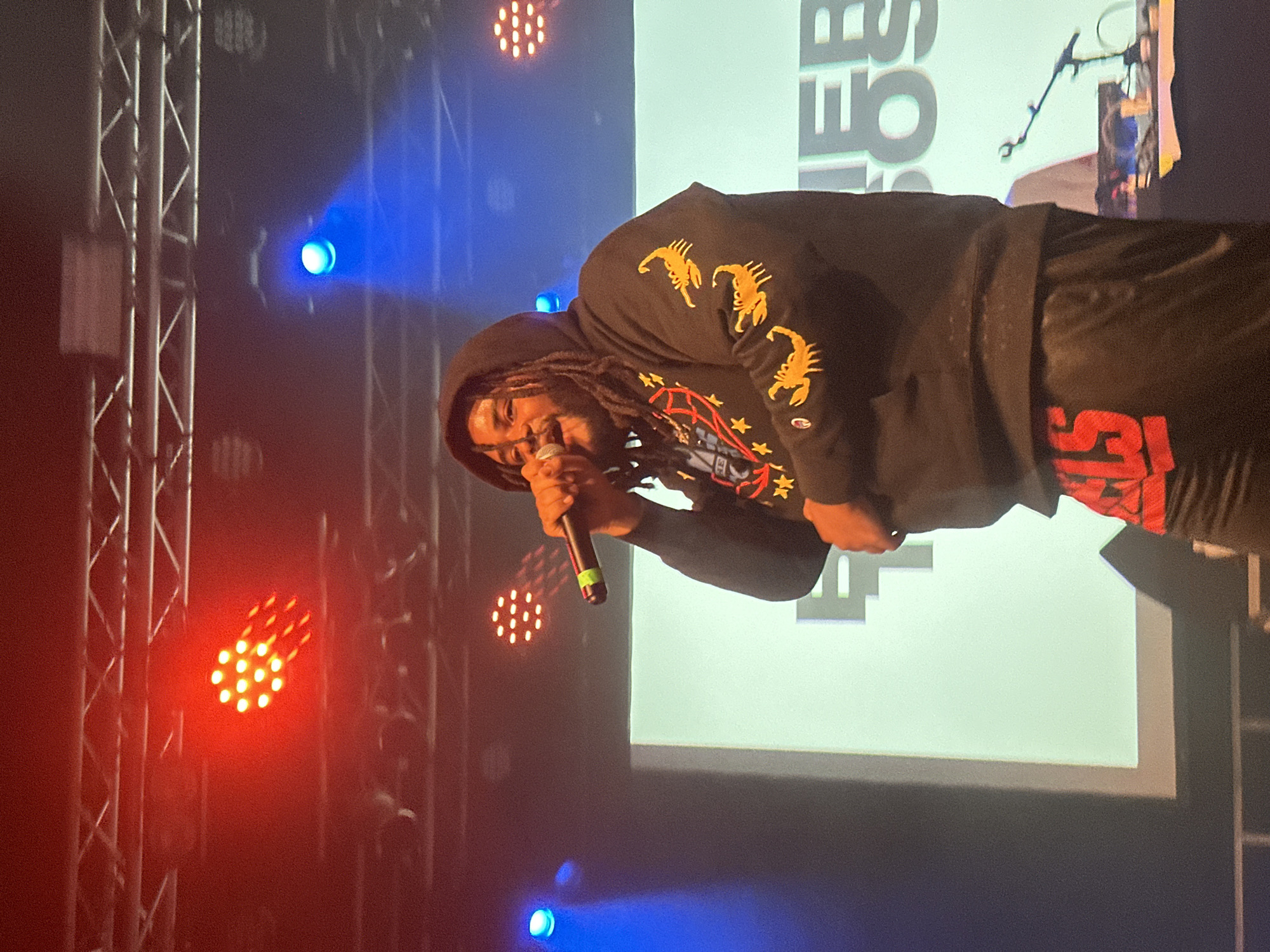Rap performance captured on stage in Cologne, Germany