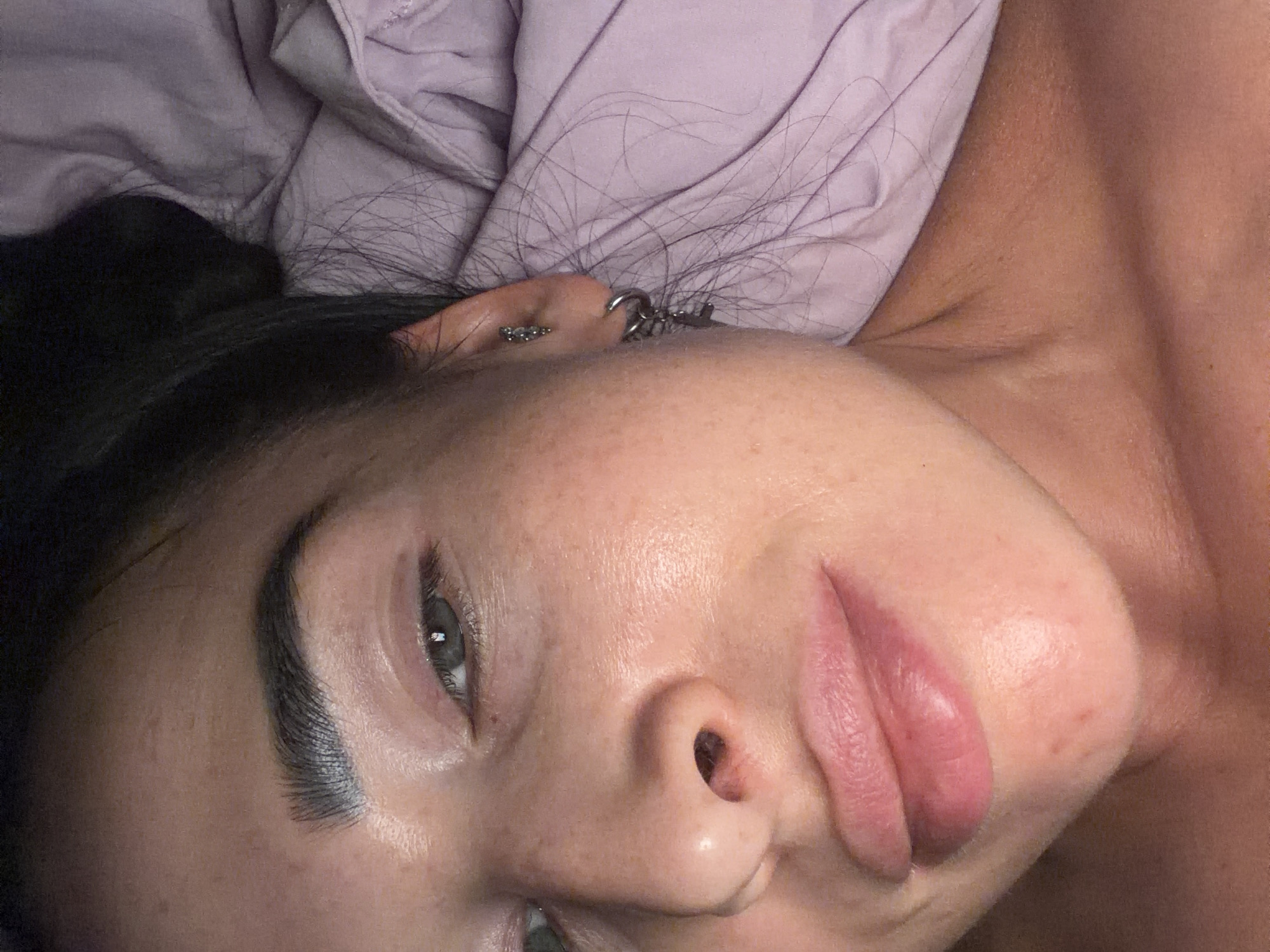 Person resting on purple bedding in Kokkorevo home