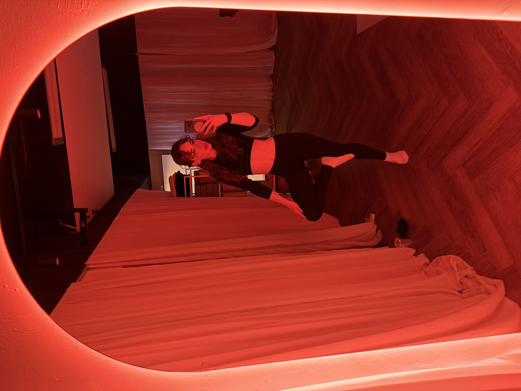 Woman takes selfie in red-lit room in Moscow