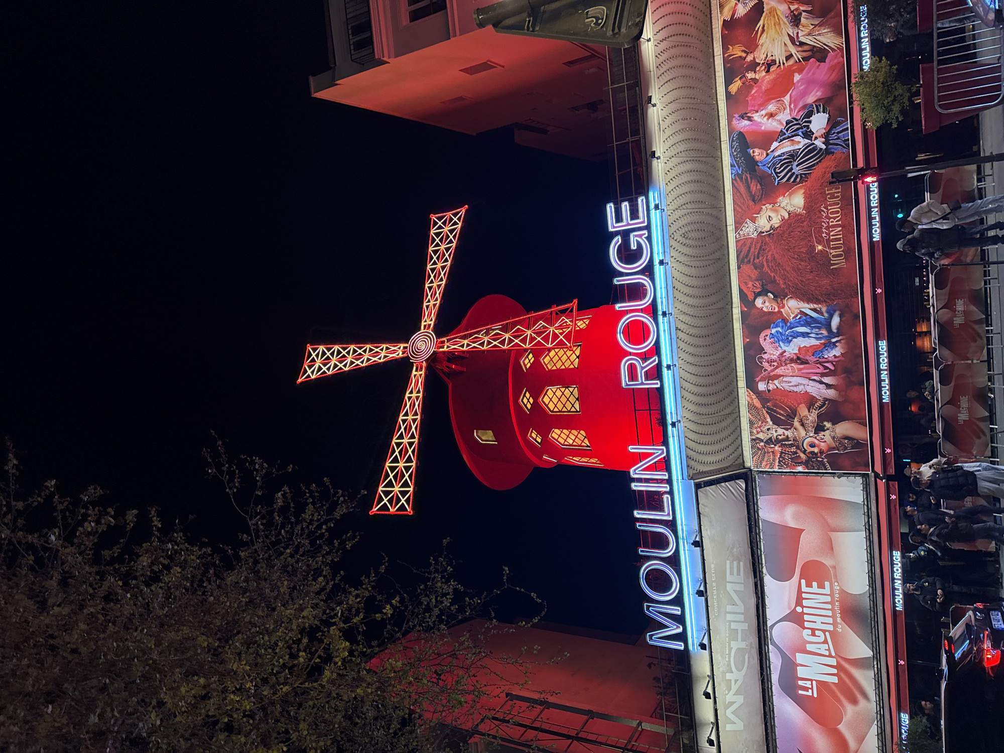 Moulin Rouge illuminated at night in Paris
