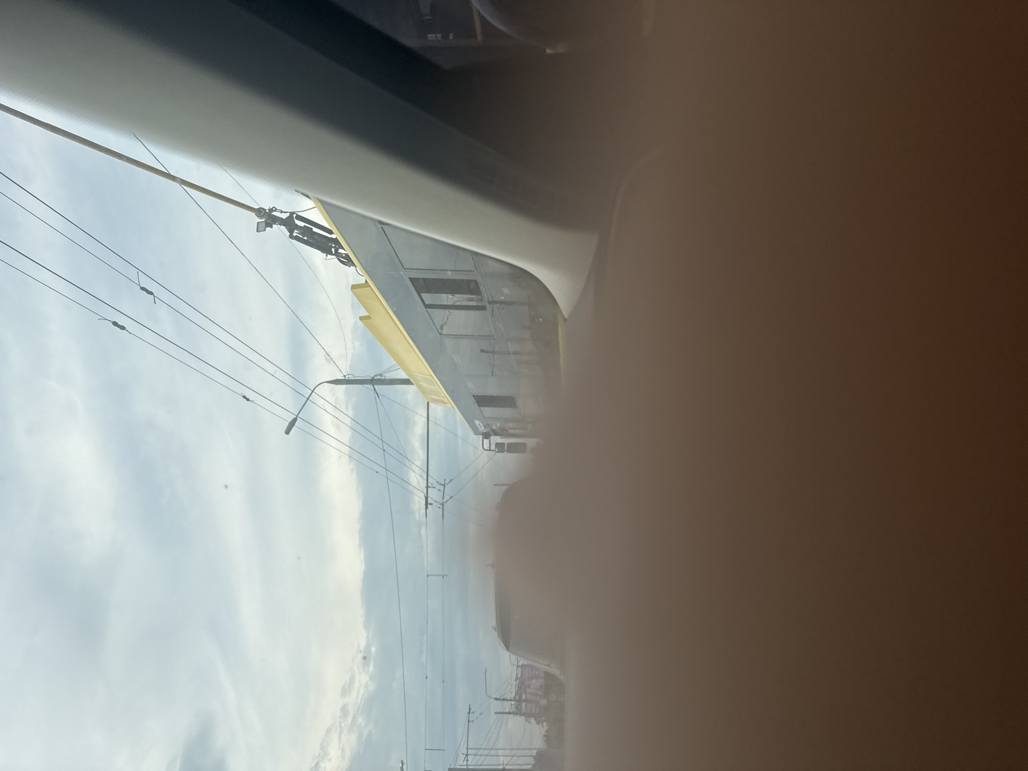 Driver Documents Street View Through Passenger Window, Finger Blocks Lens