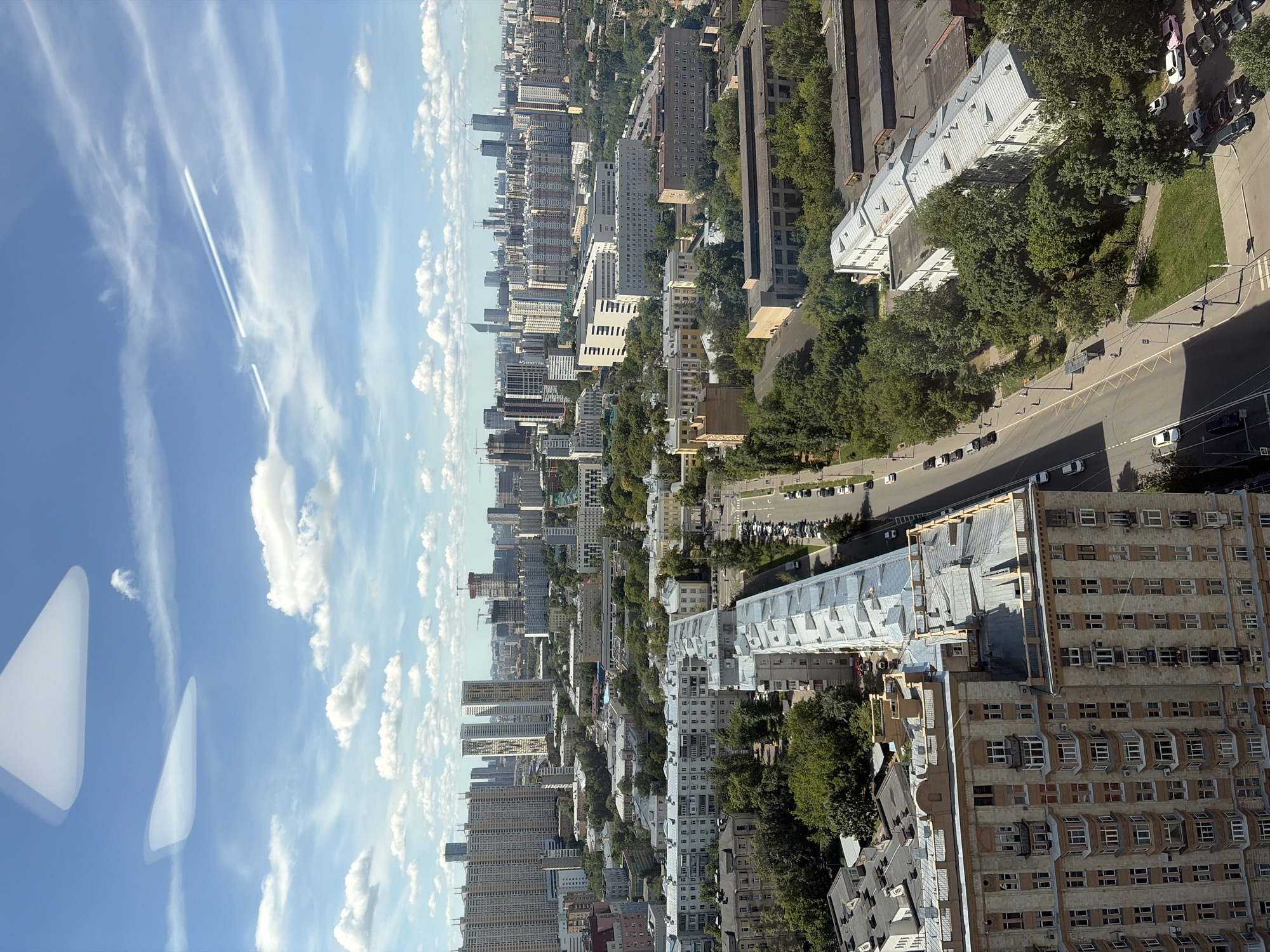 High-altitude aerial view over a dense city below