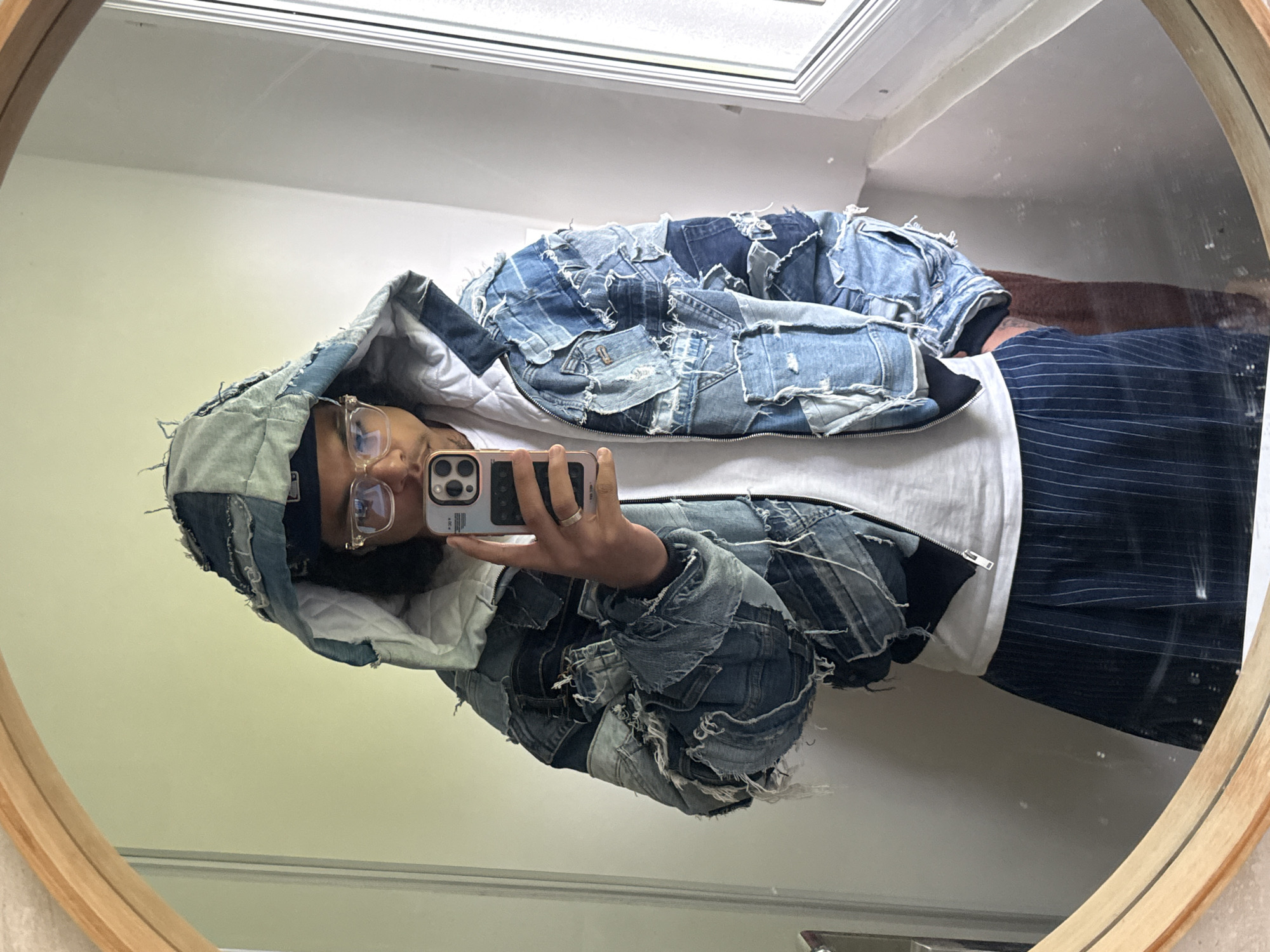 Person takes mirror selfies in distinctive denim jacket, Massy