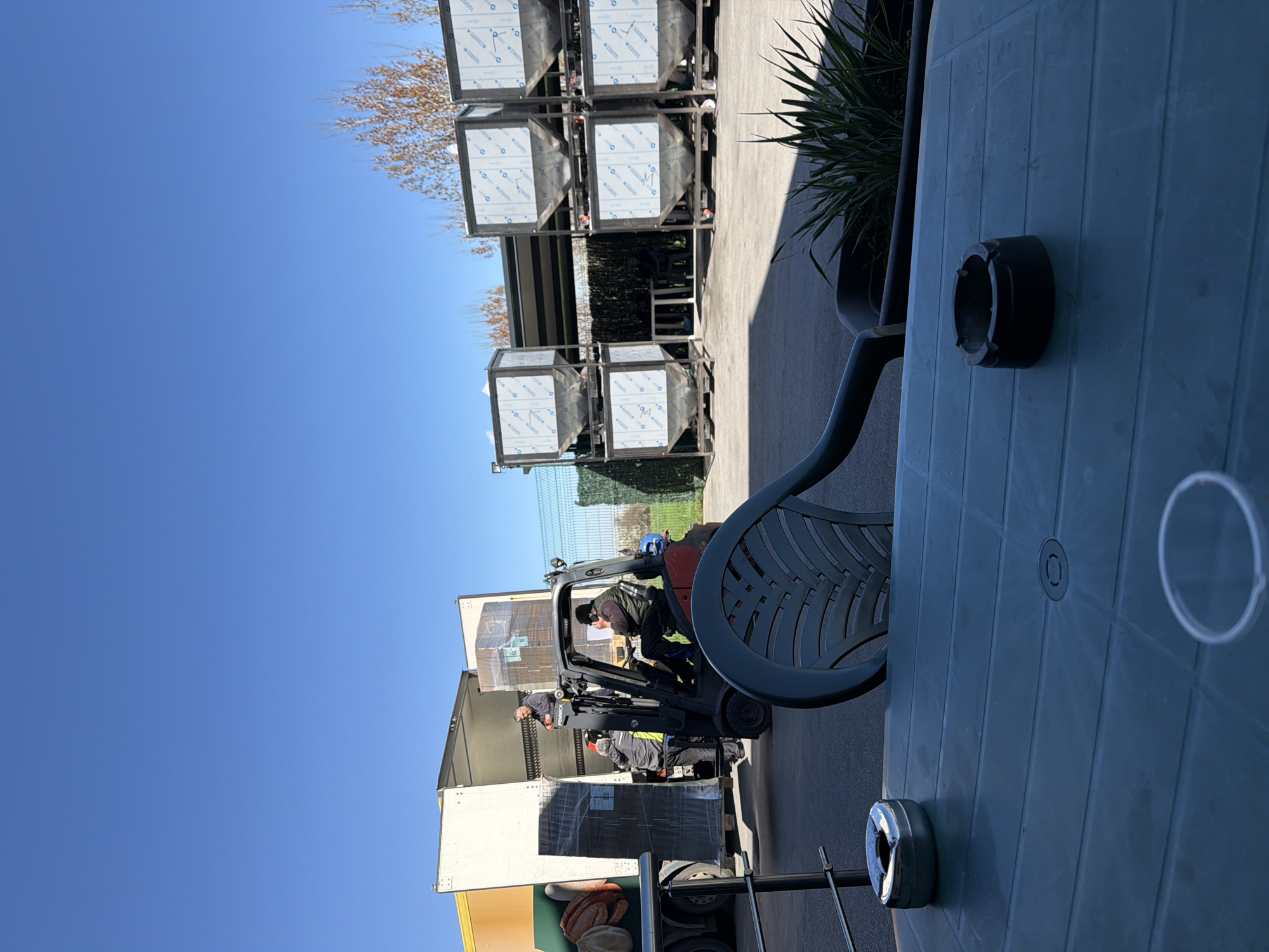 Forklift unloads trailer with crew assistance in Lozen, Bulgaria