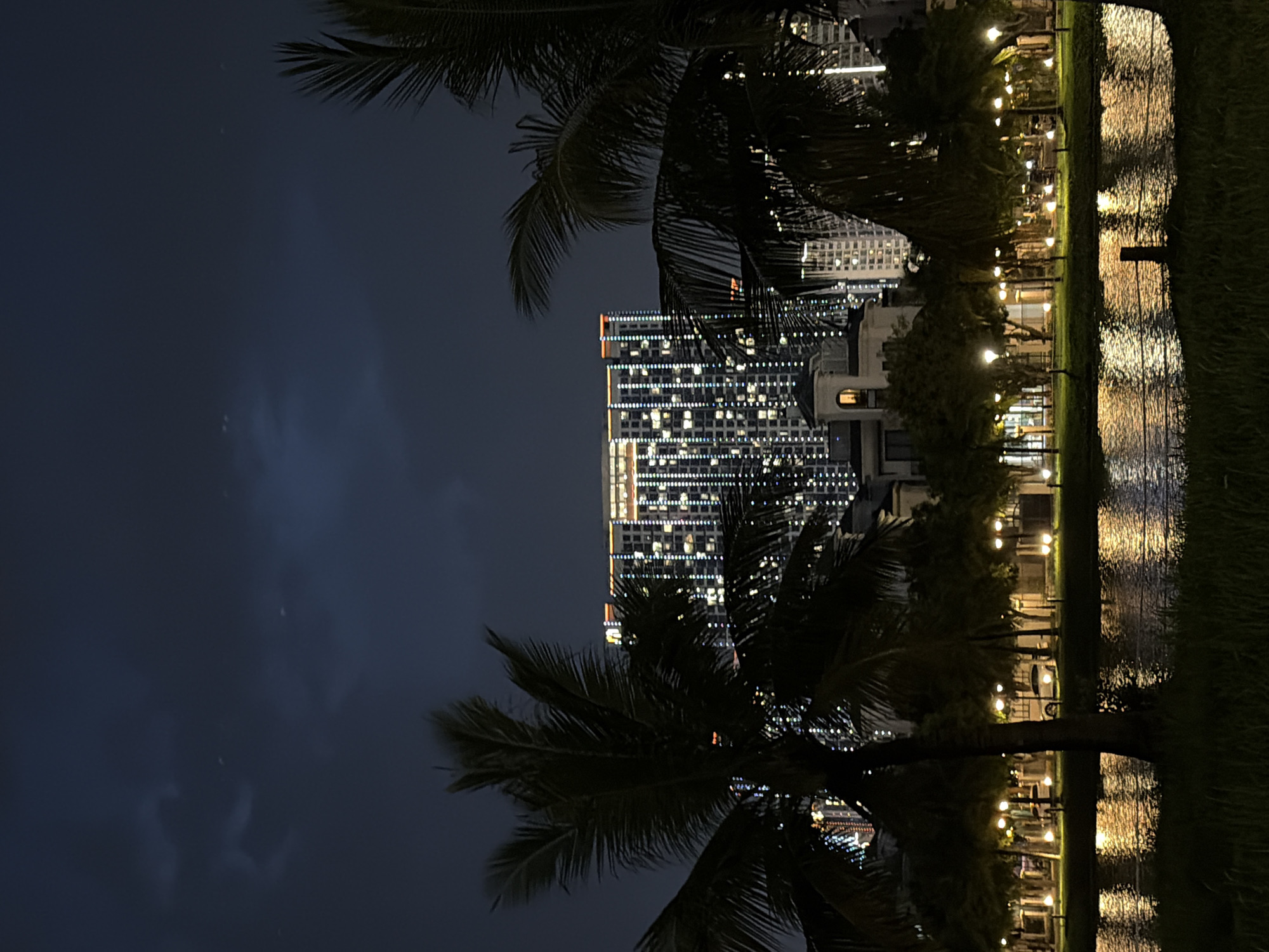 Hanoi lakeside district at night, parks and lit skyline