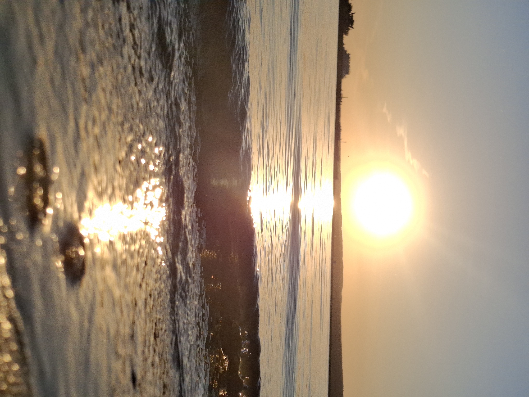 Sunset captured over water with golden reflections