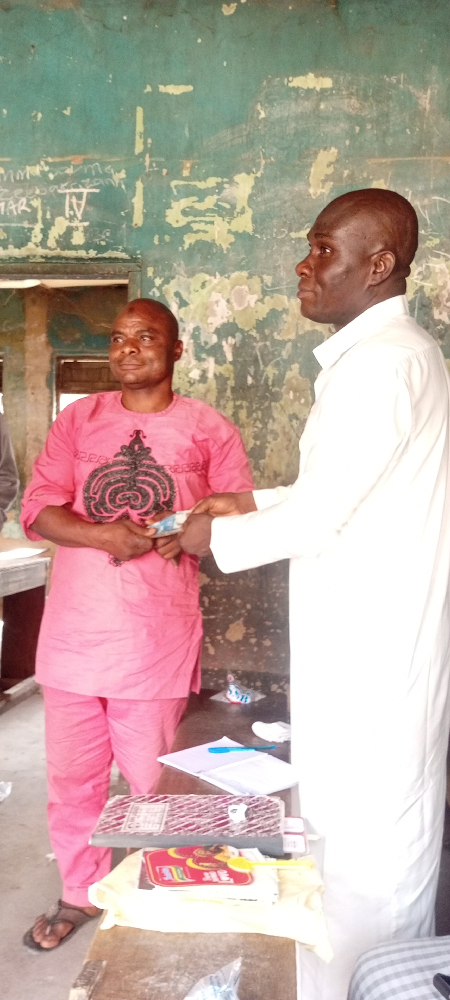 Money exchange between two men in public building