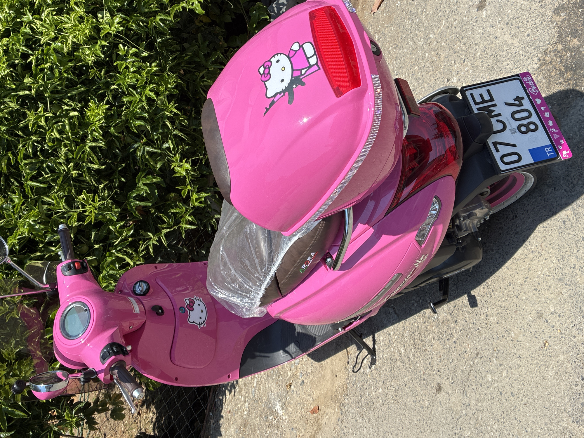 Hello Kitty scooter parked among greenery in Alanya