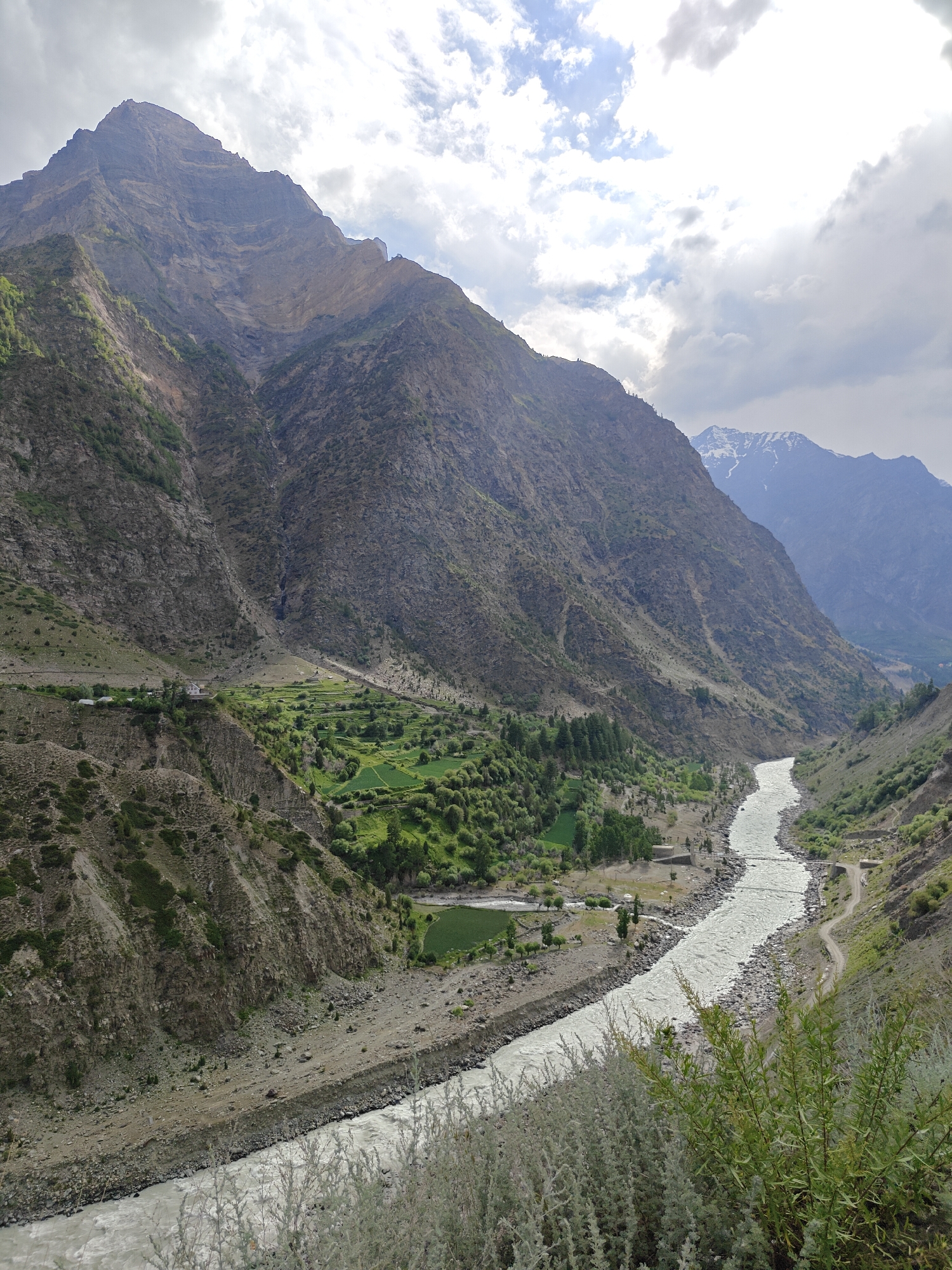 Riding through Kirting's glacial river valley in the Himalayas