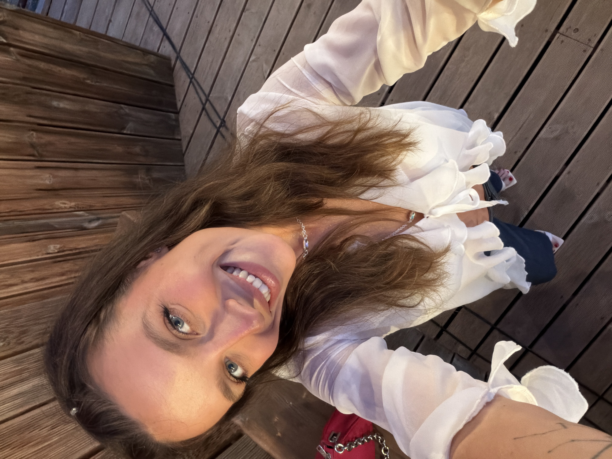 Woman takes smiling selfie in Bigova, Montenegro