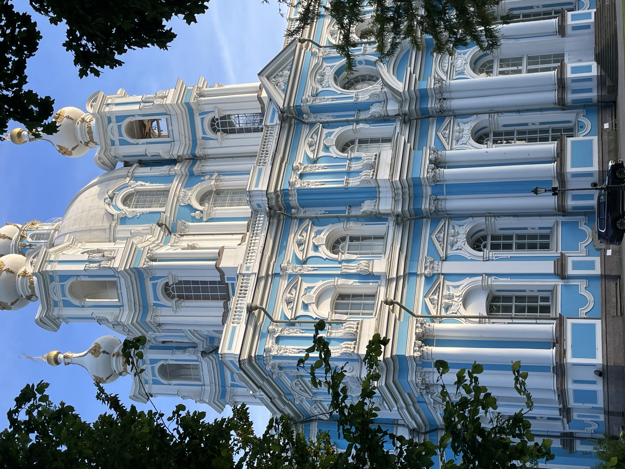 Tourist documents Russian architecture, takes selfies in afternoon sunlight