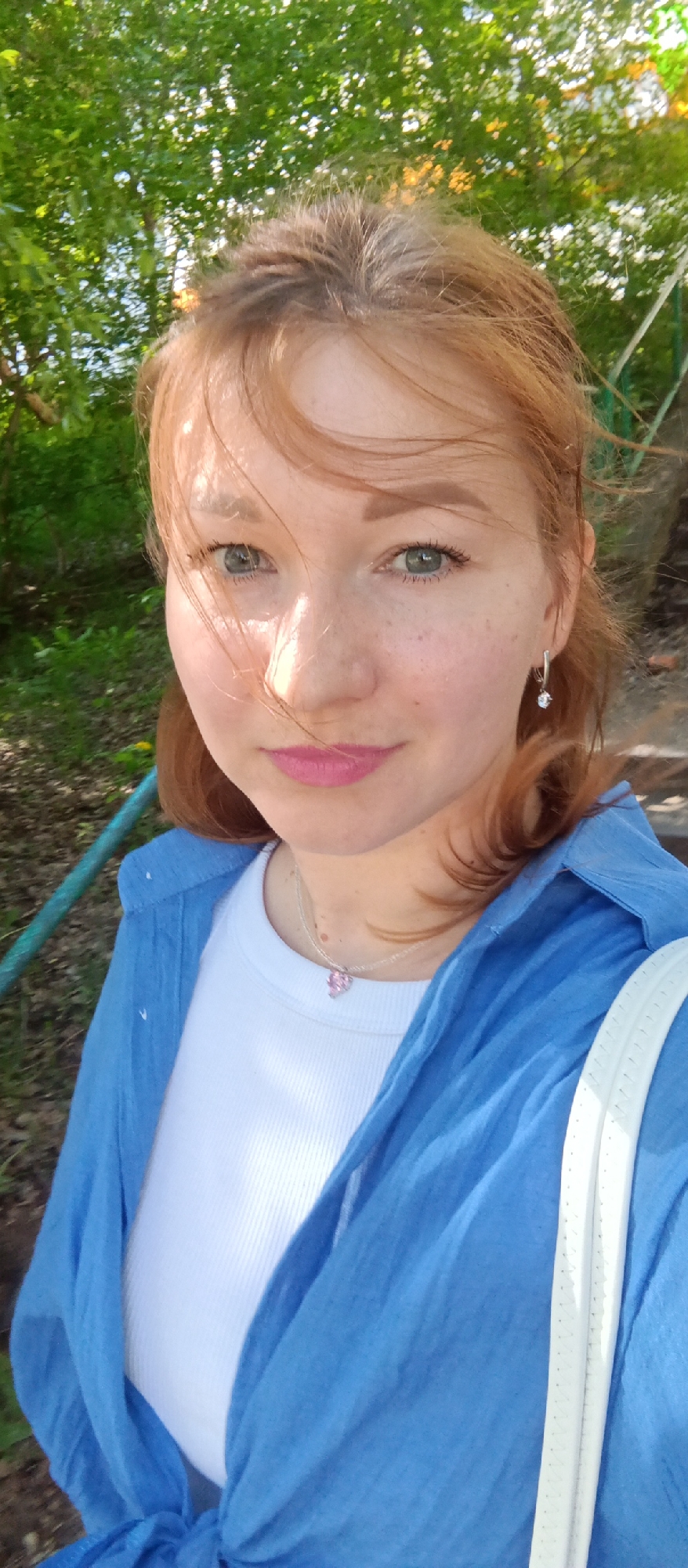 Red-haired woman photographed taking selfies indoors over 16 minutes