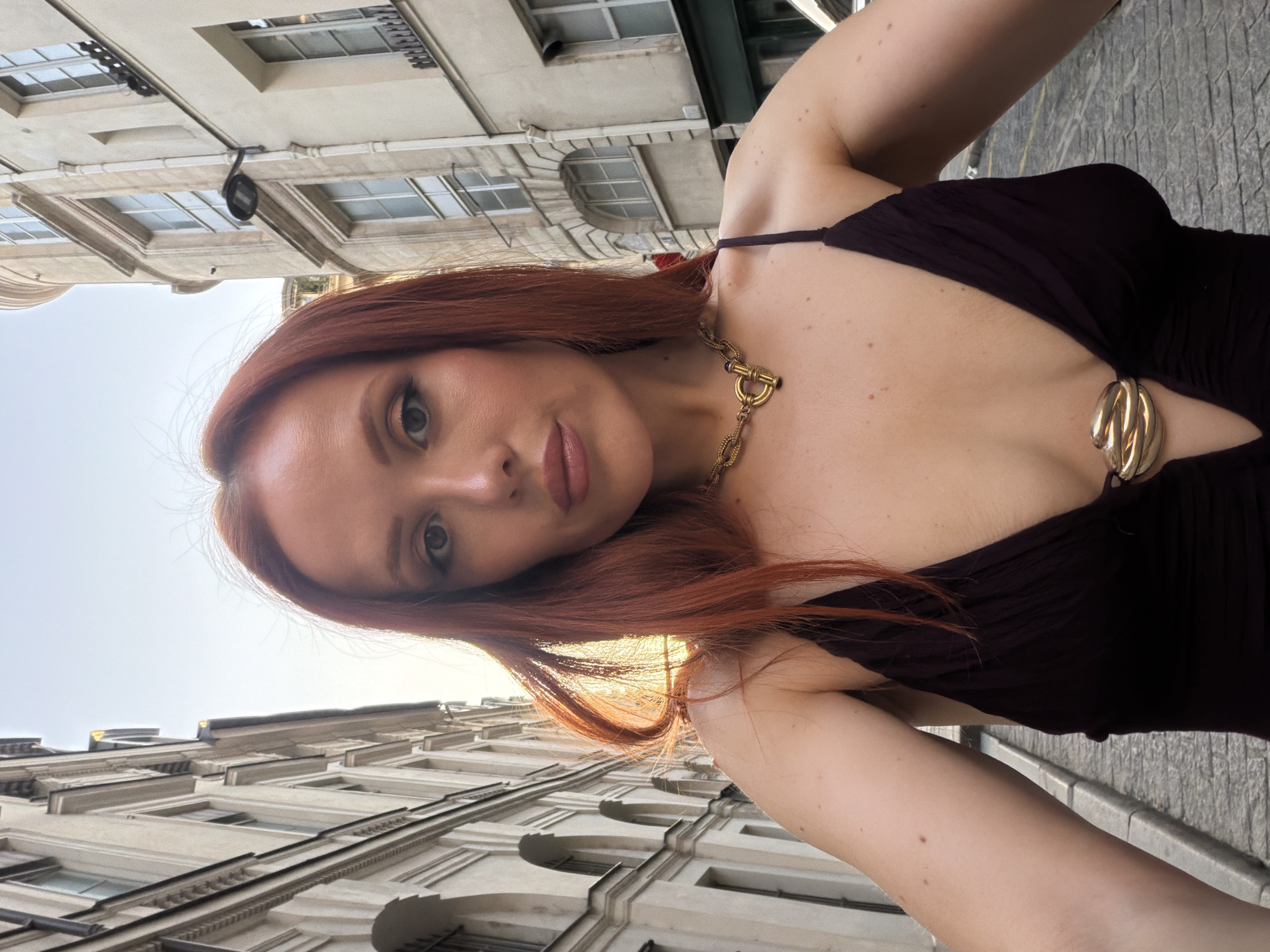 Woman takes selfie among Paris buildings