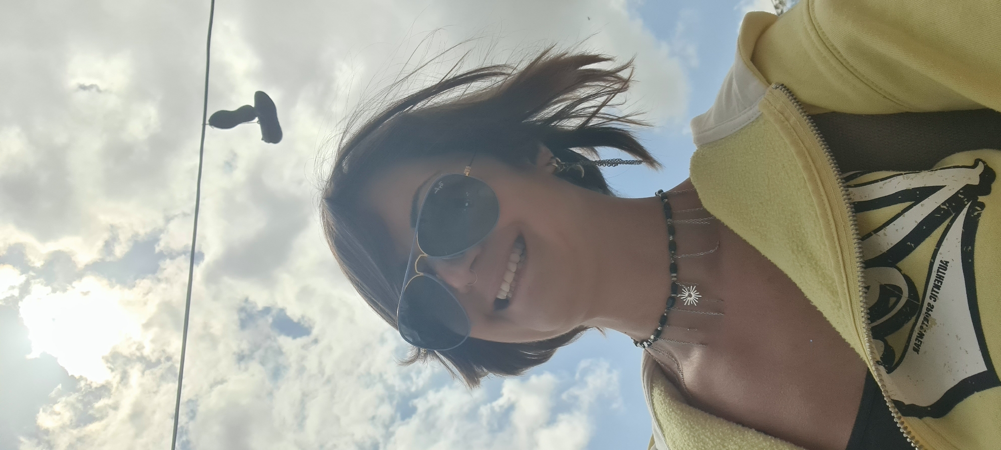Woman photographed outdoors in yellow hoodie, Lachish Regional Council