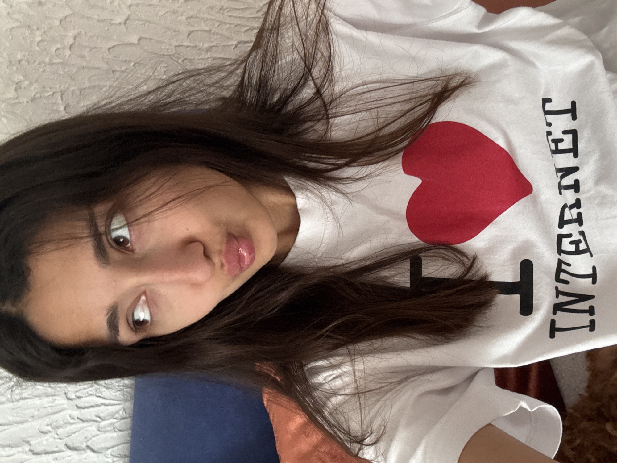 Woman in Internet-themed shirt photographed lying down in Montenegro