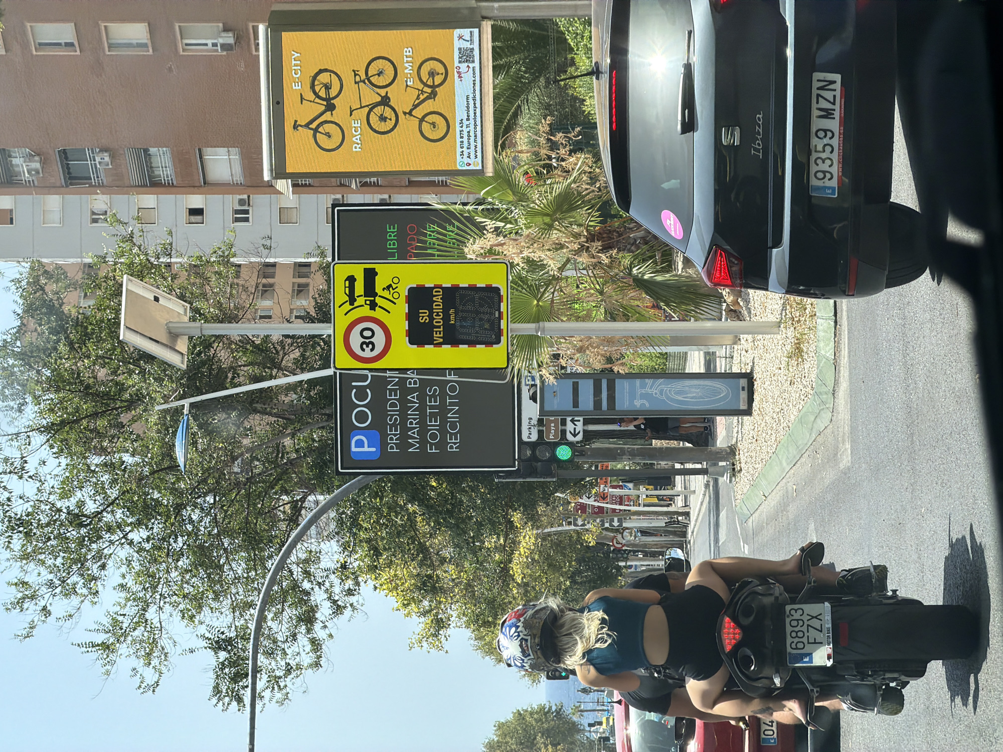 Midday traffic and street life in sunny Benidorm