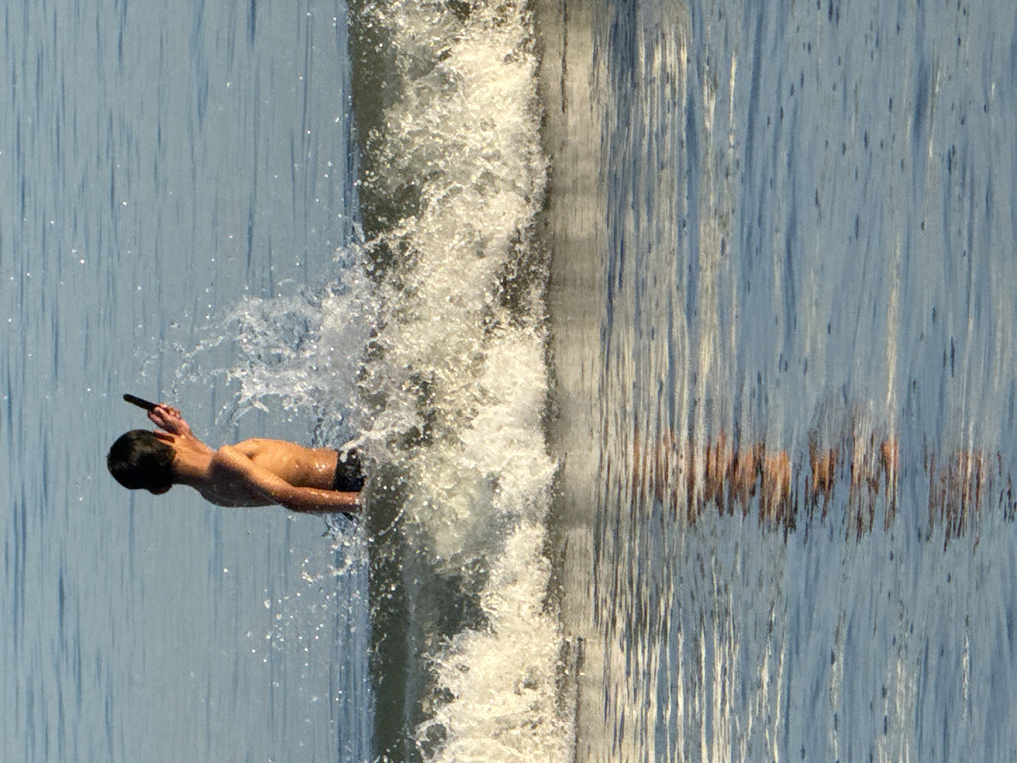 Evening beach play: families enjoy surf at Indonesian beaches