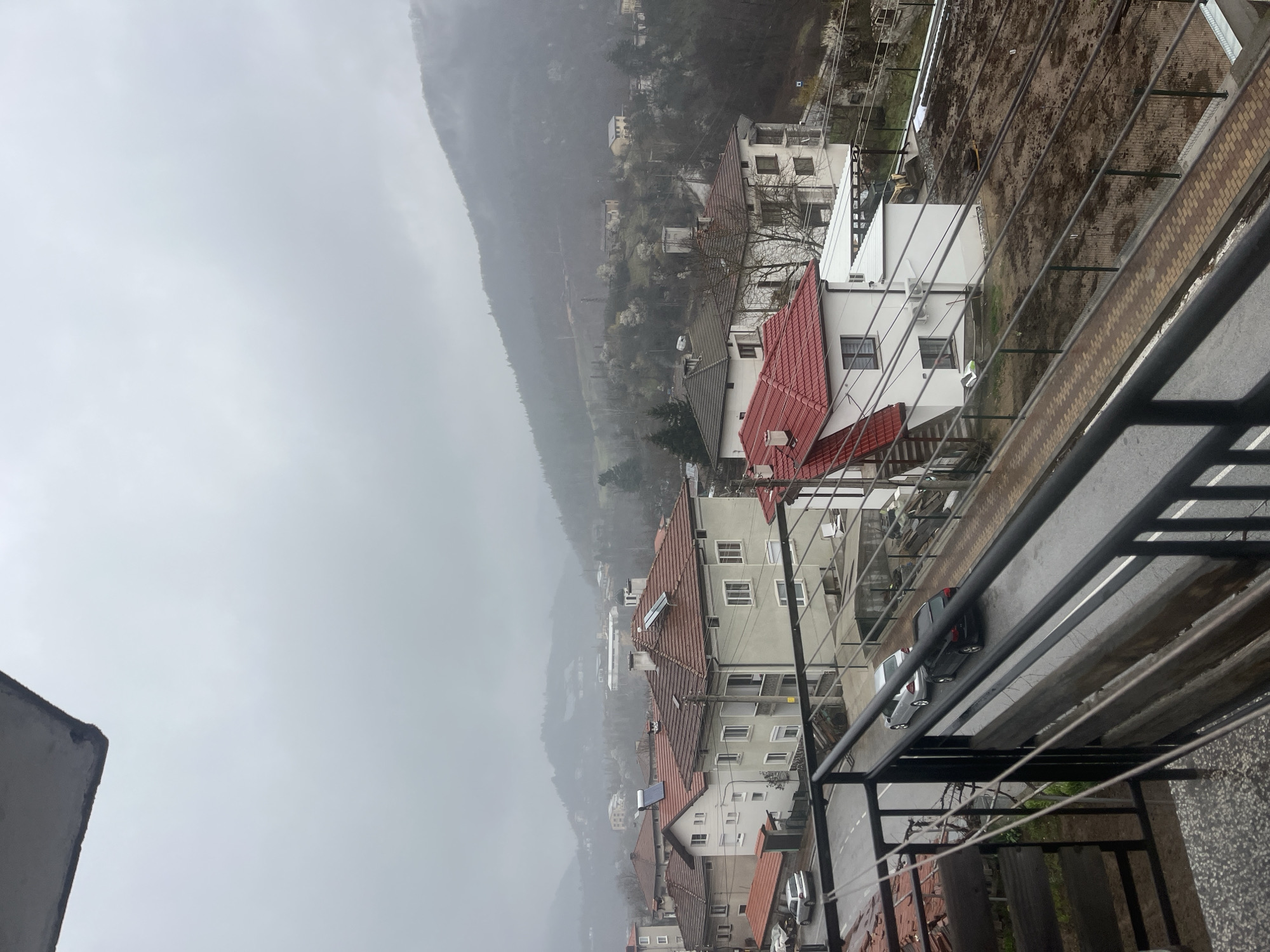Foggy conditions obscure mountains over Bulgarian residential area