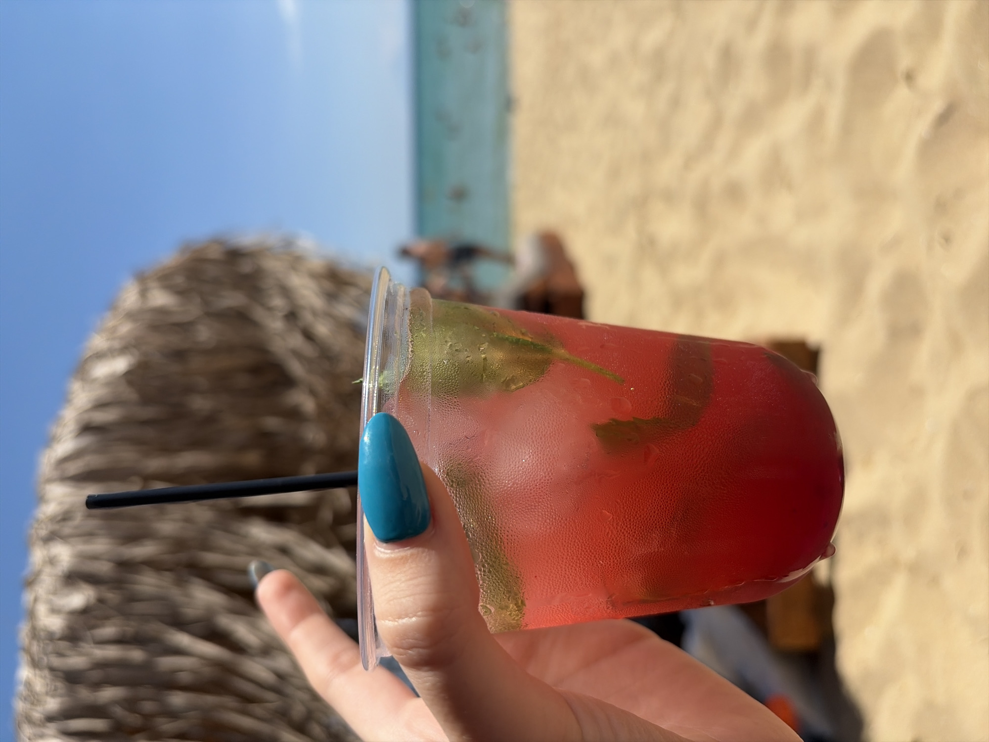Cold drinks and thatched shade on a Greek beach afternoon