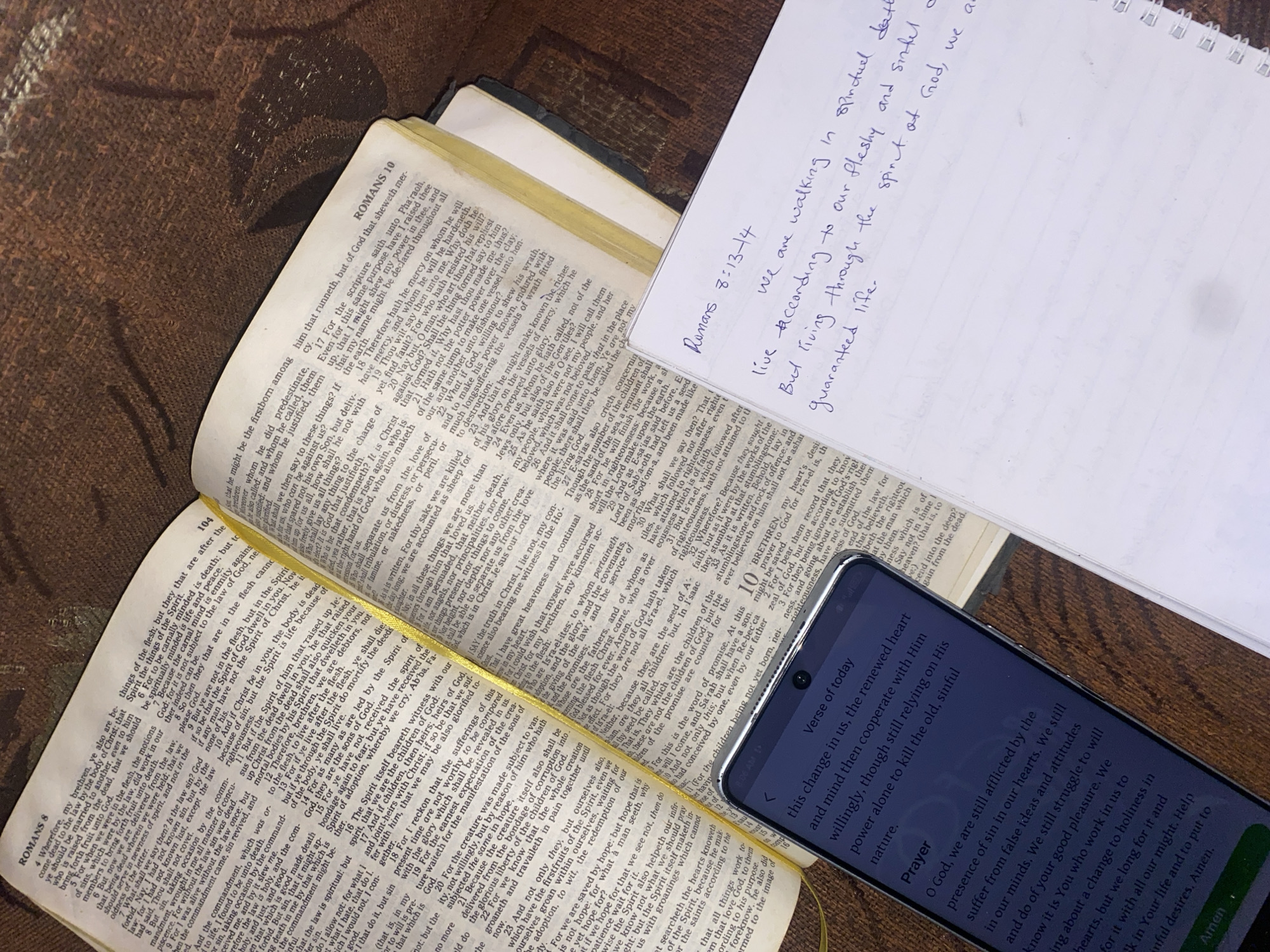 Study materials including Bible arranged on fabric surface
