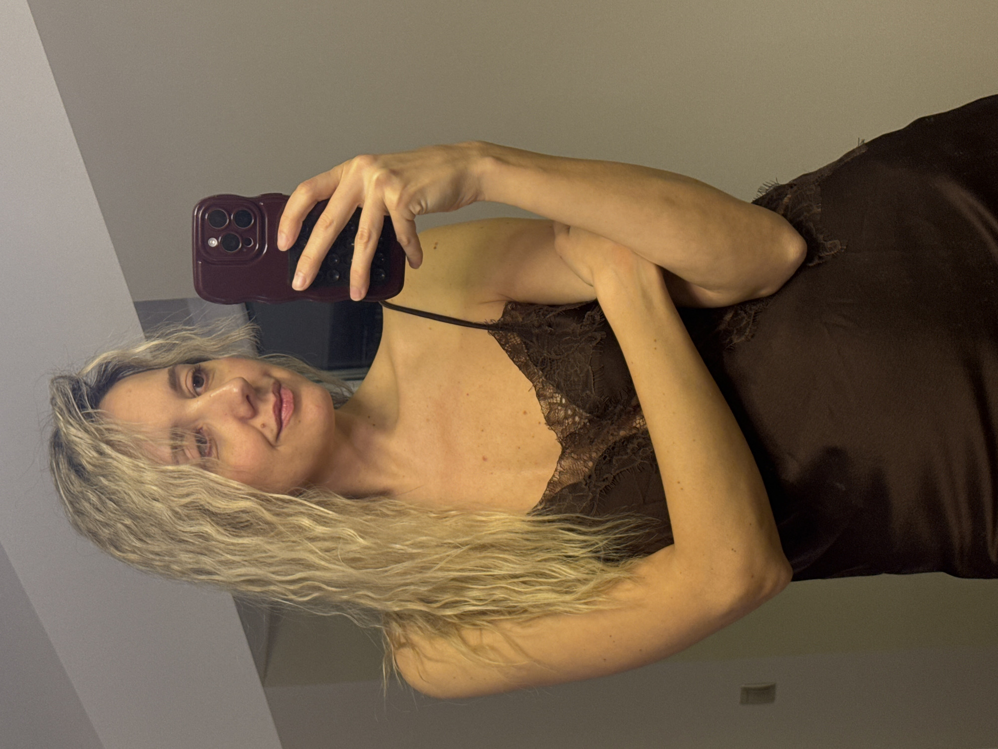 Woman takes multiple selfies indoors in Carnikava, Latvia