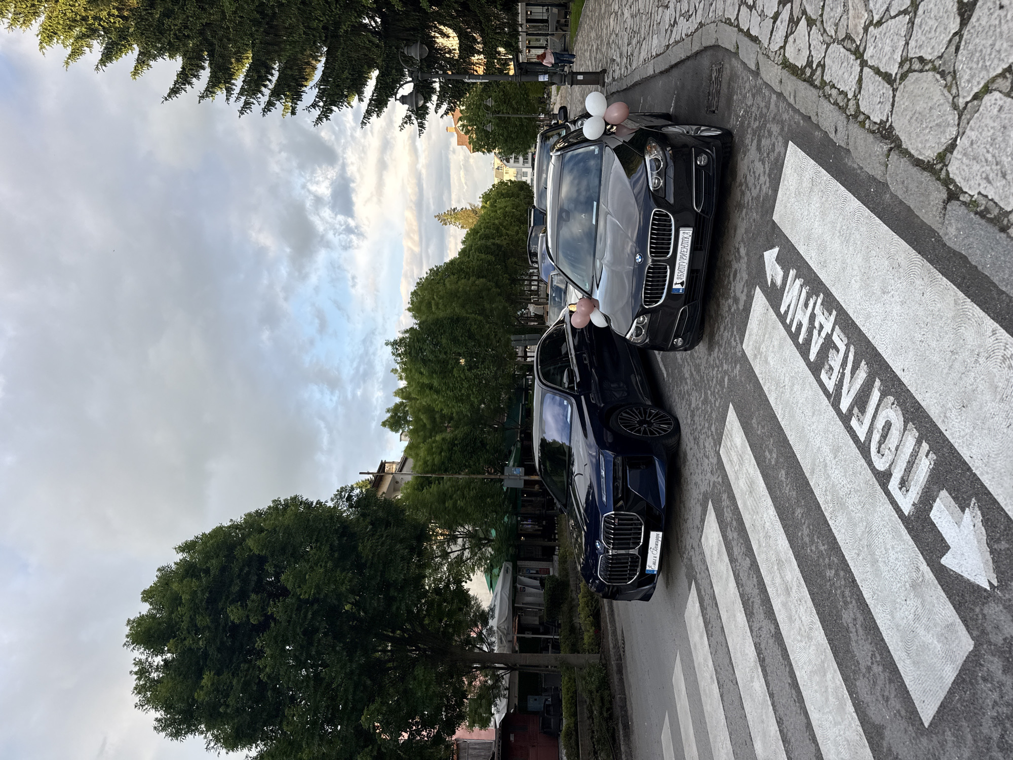 Cars parked near shops in Razlog, Bulgaria street scene