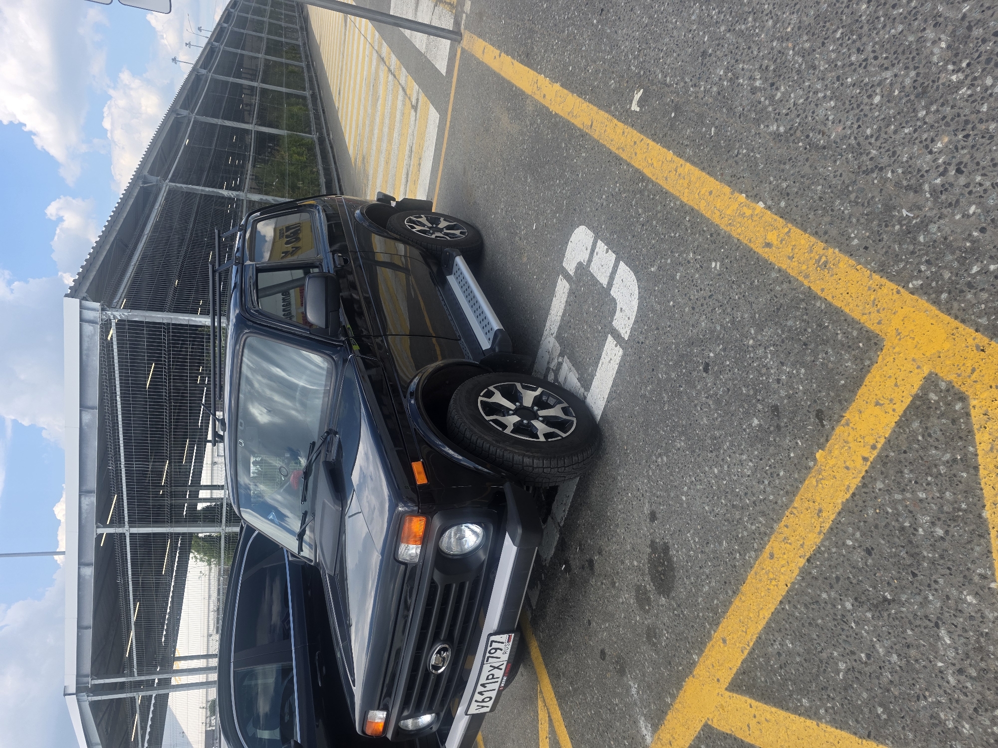 Vehicles parked, dog spotted on leash in retail area
