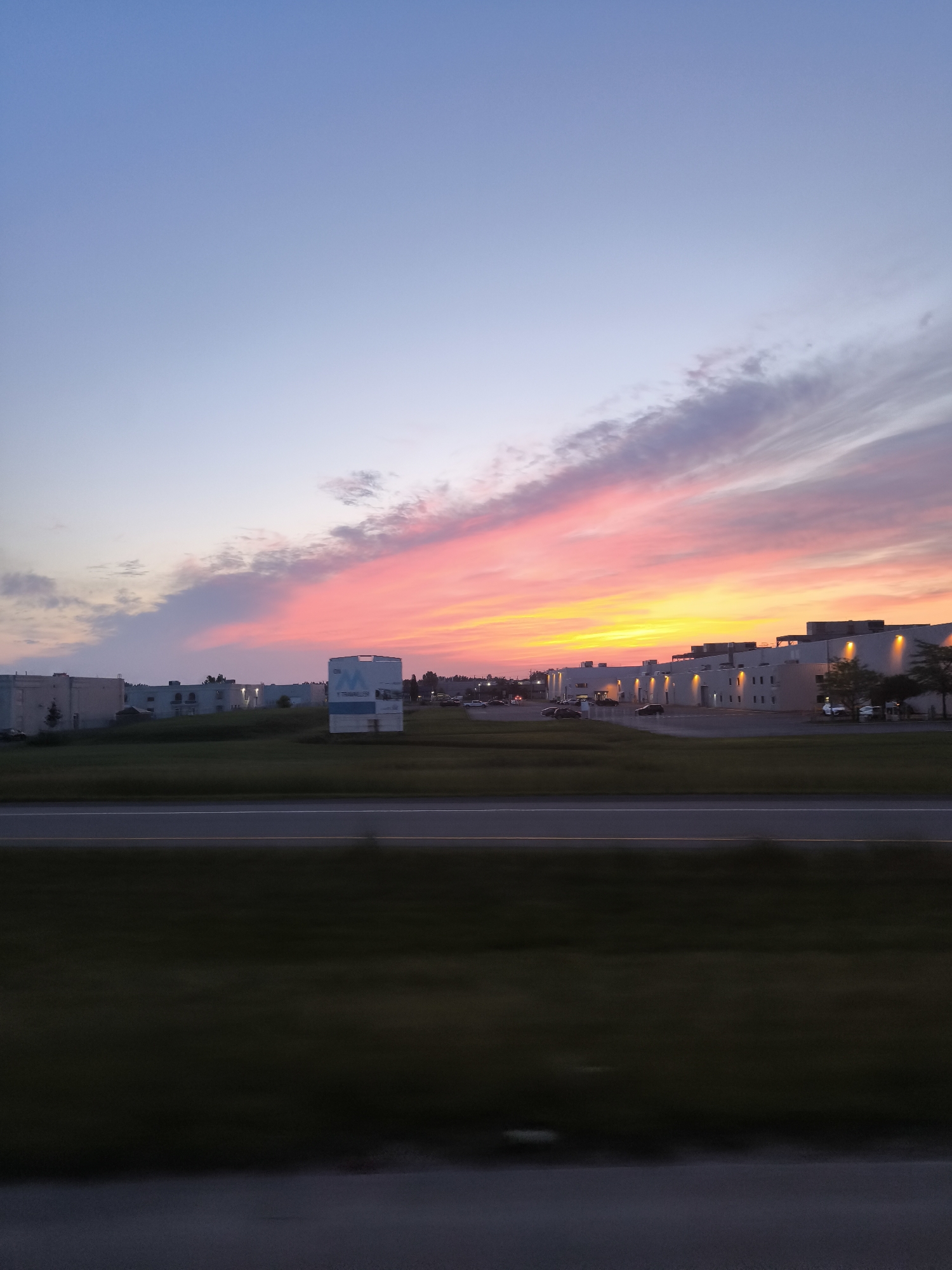 Vivid summer sunset over Mirabel's commercial strip