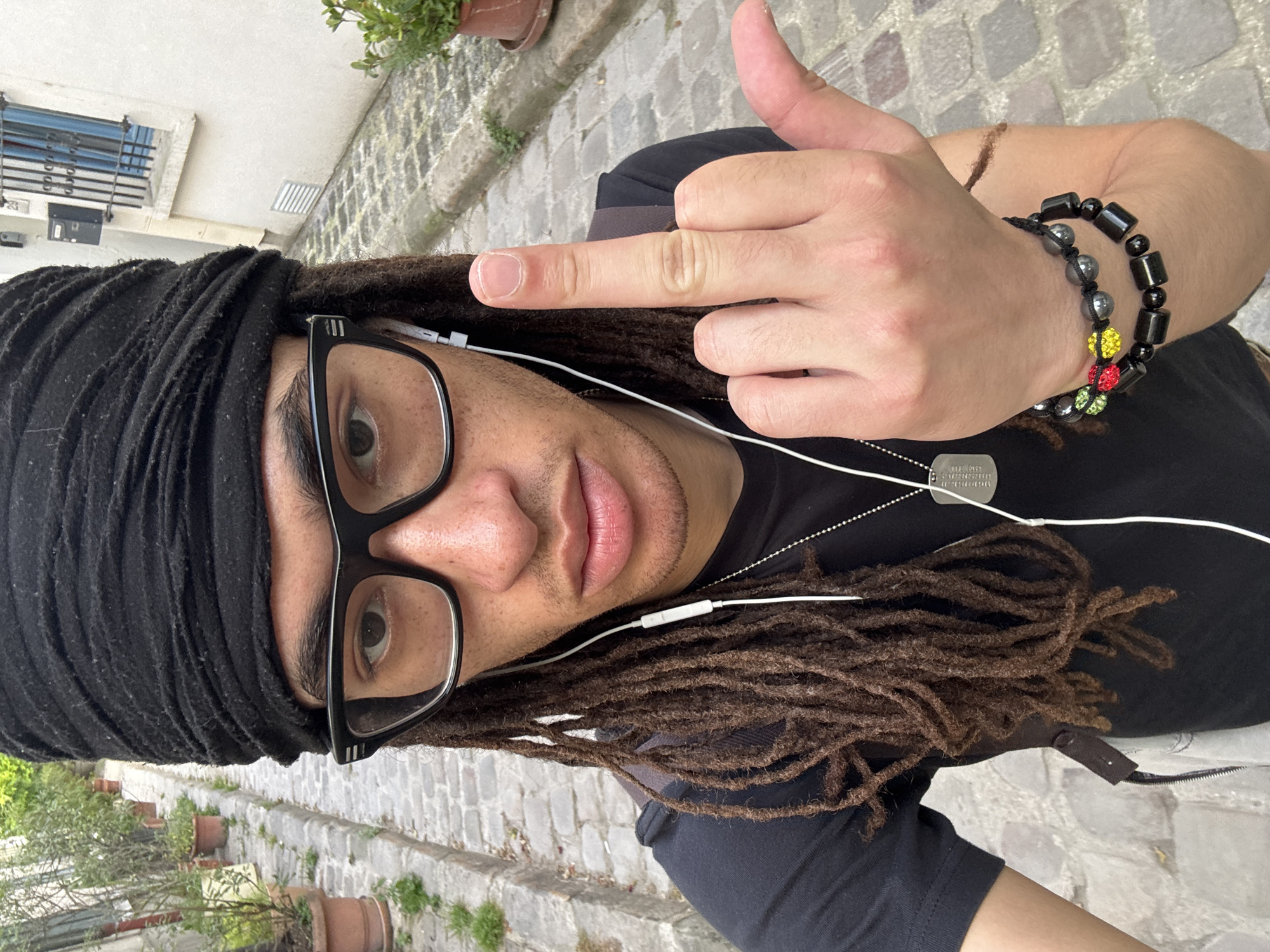 Person in black head wrap photographed in Paris