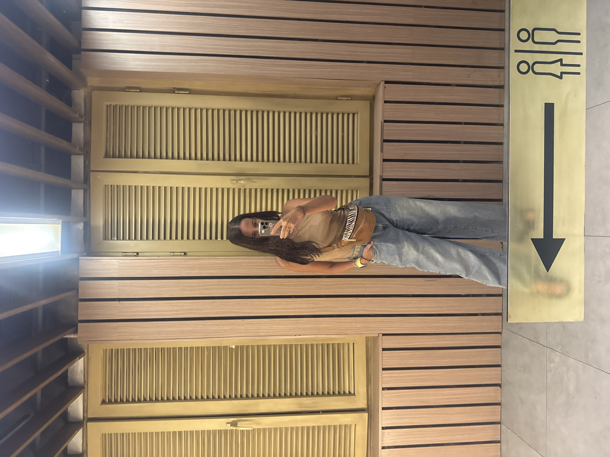 Woman Takes Mirror Selfie in Kuta Selatan Indoor Setting