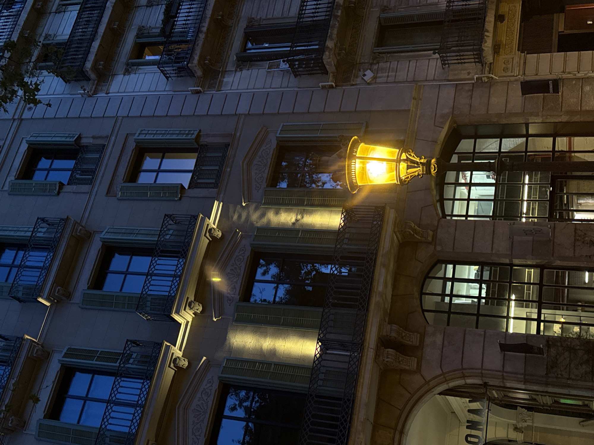 Barcelona building facade documented at night with ornate balconies