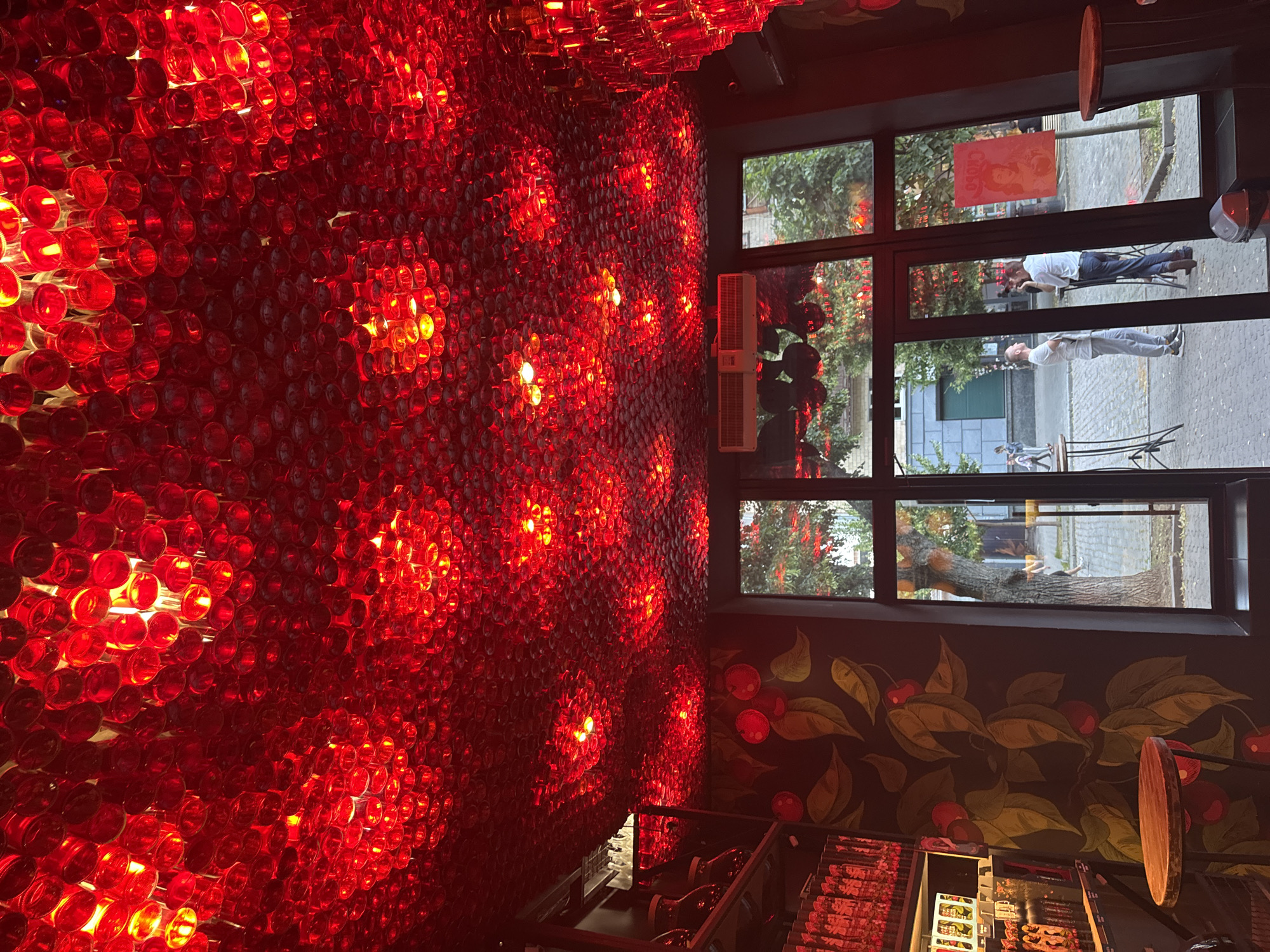 Red bottle chandeliers and flower beds in Poltava