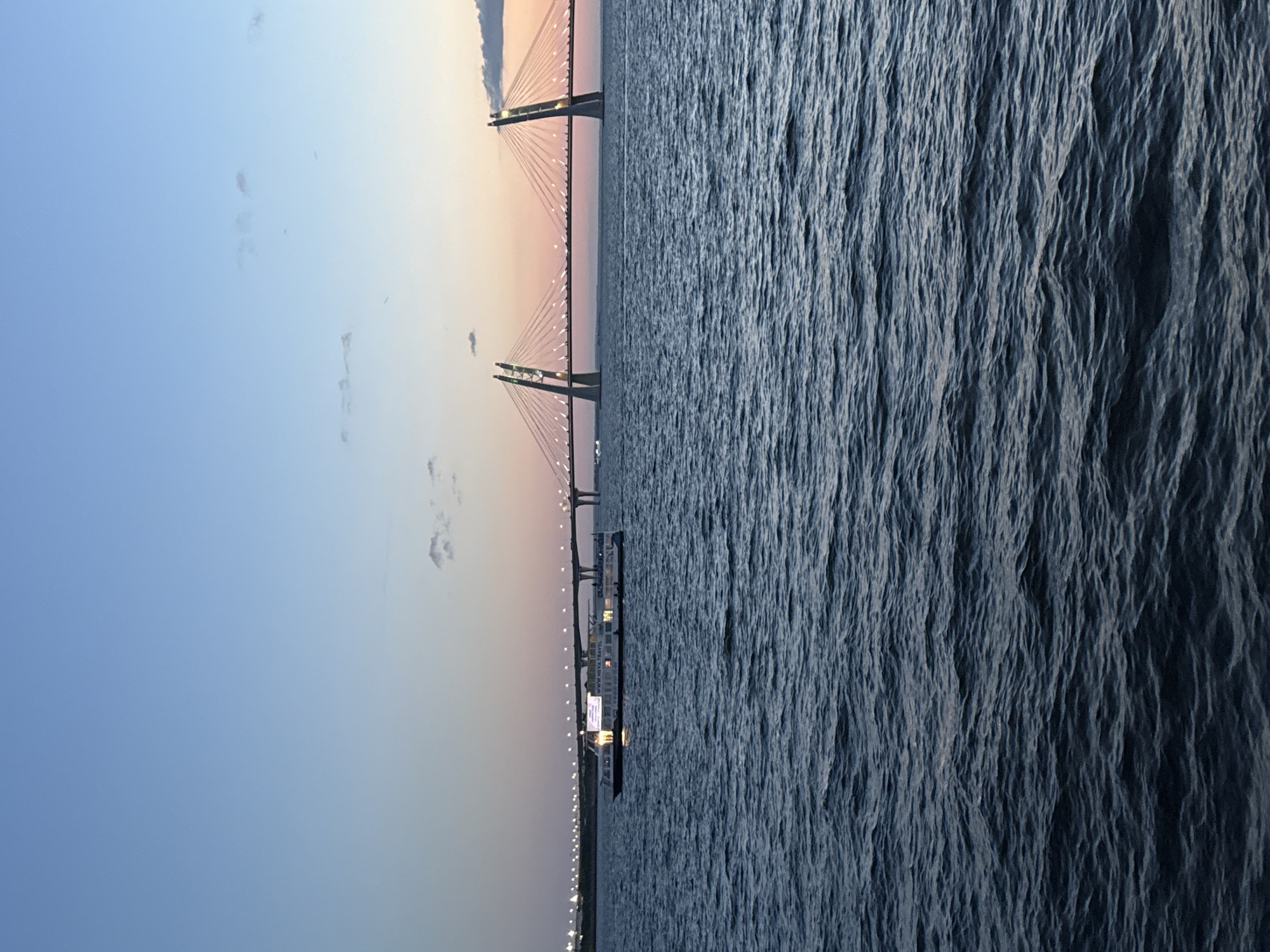 Illuminated cruise boat on the Gulf of Finland at dusk