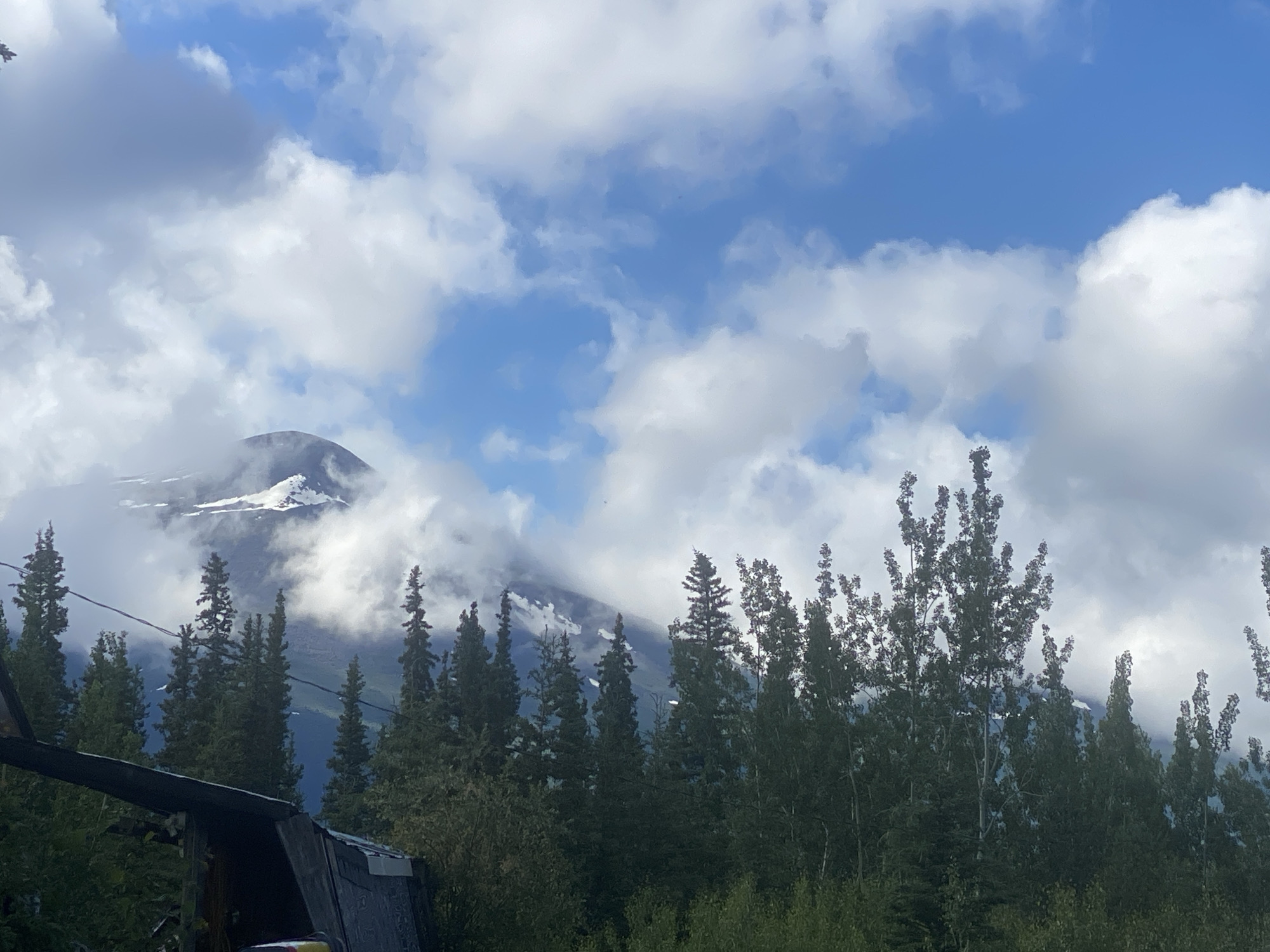 Truck parked roadside amid Haines Junction mountain wilderness