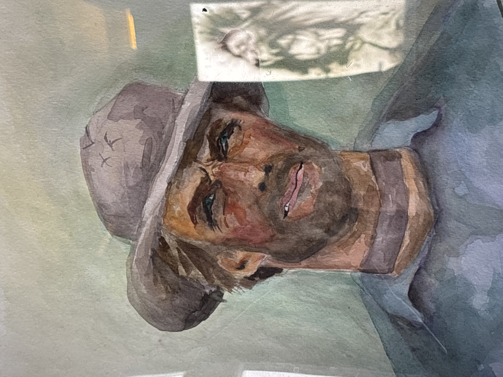 Watercolor portrait of hatted man in blue shirt documented