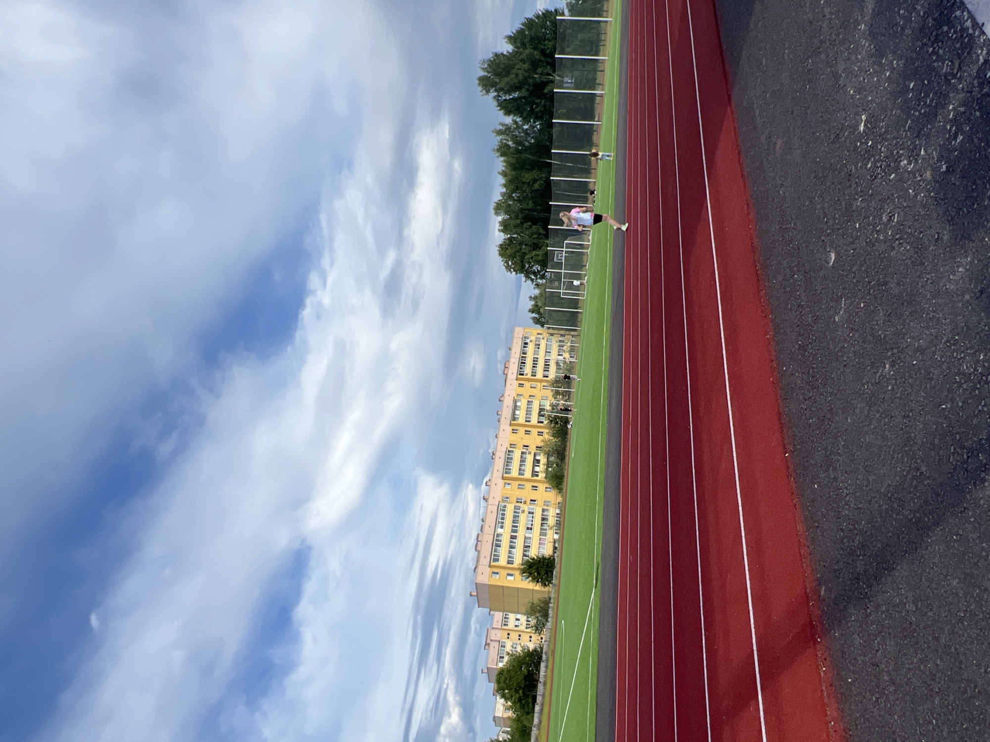 Lazy summer day at a Noviy sports track and nearby homes