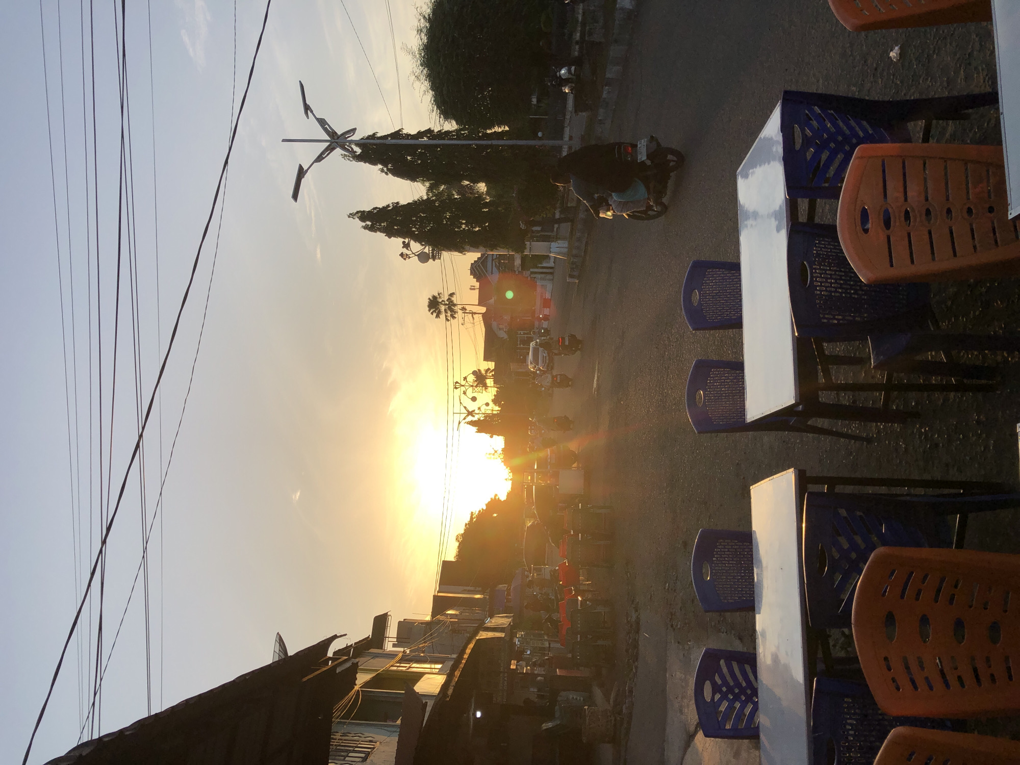 Sunset light spills across a Lhokseumawe city street