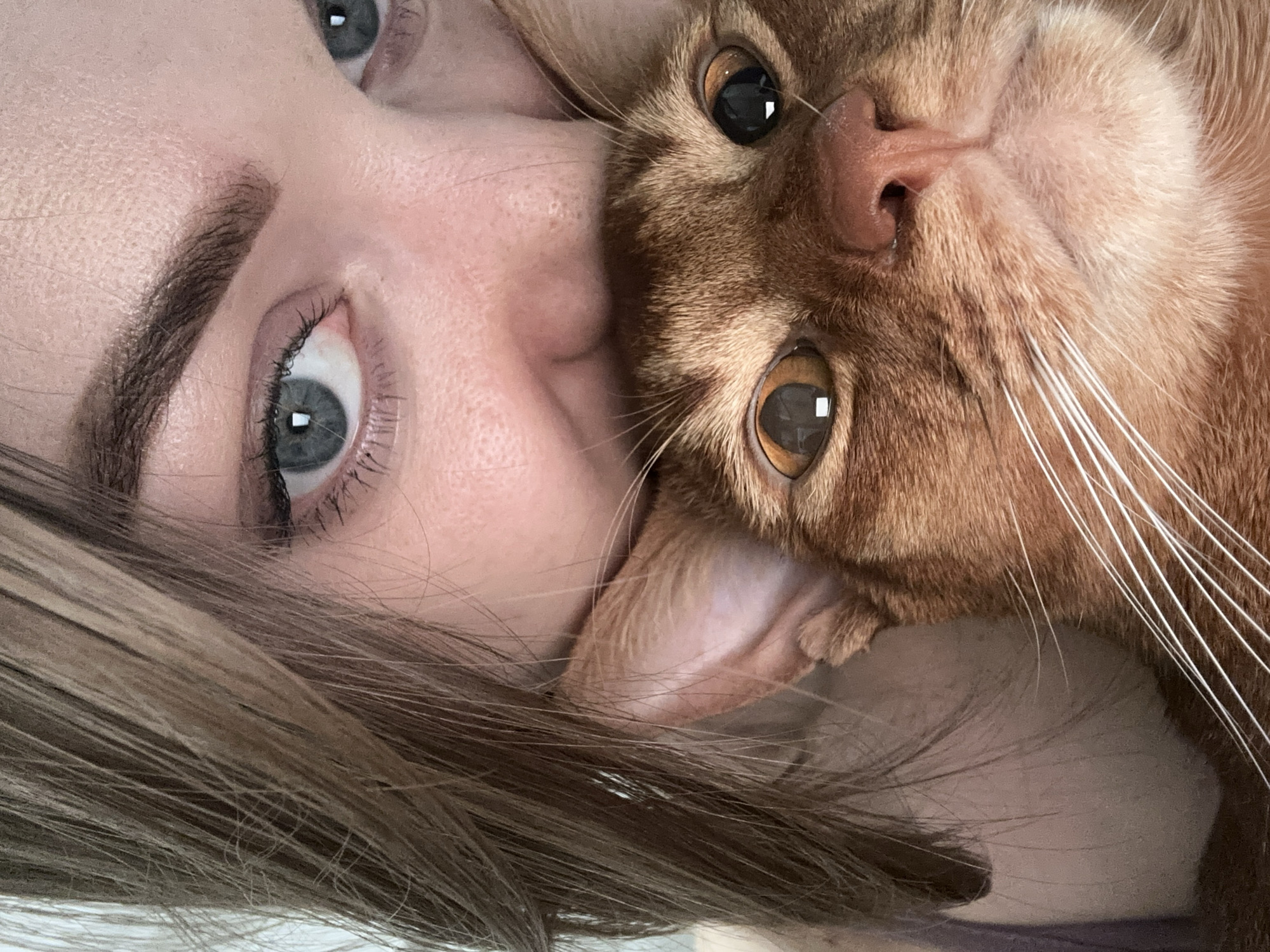 Woman poses with orange cat in Kazan selfie